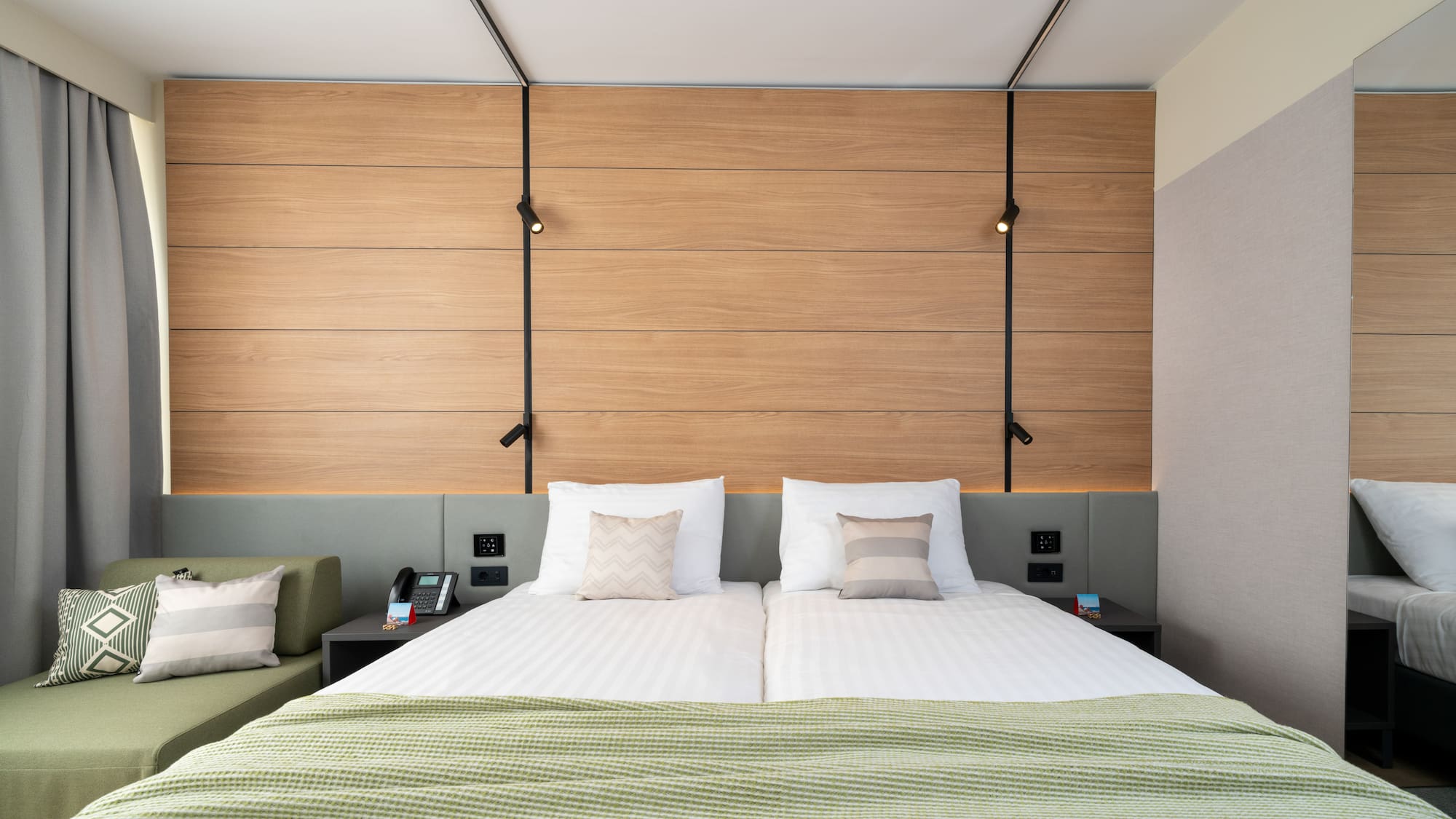 a bed with pillows and a green couch