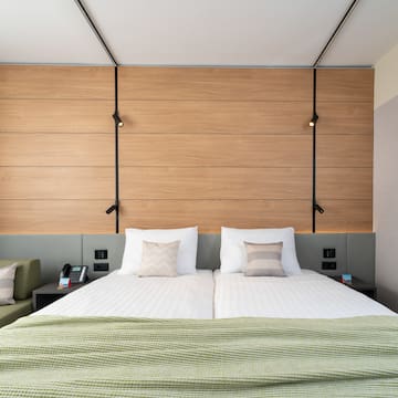 a bed with pillows and a green couch