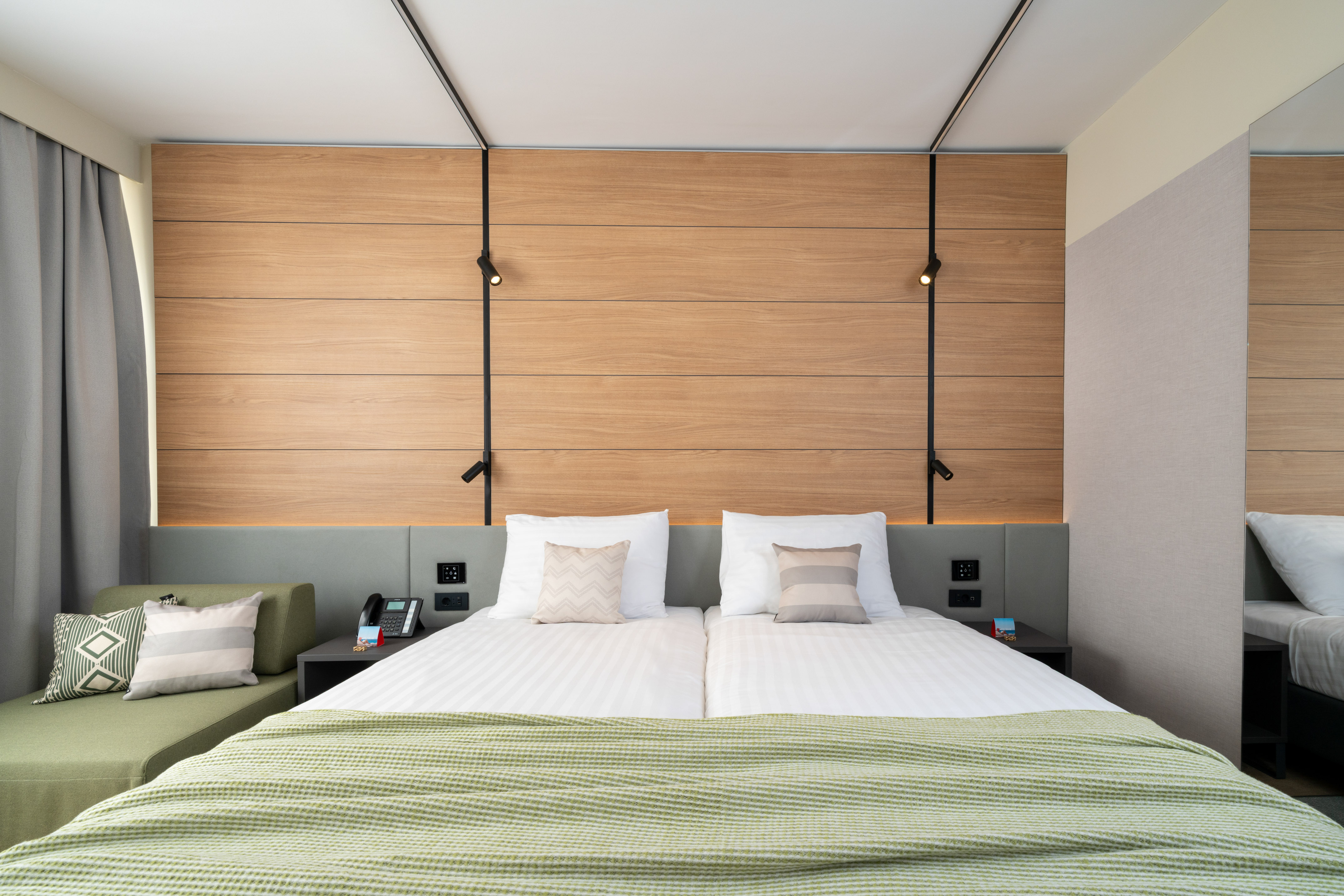 a bed with pillows and a green couch