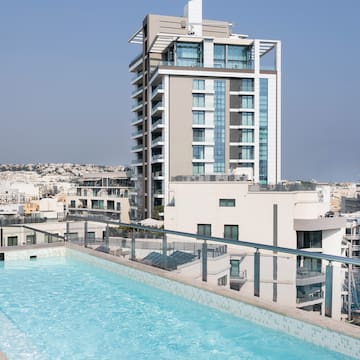 a pool on a rooftop overlooking a city