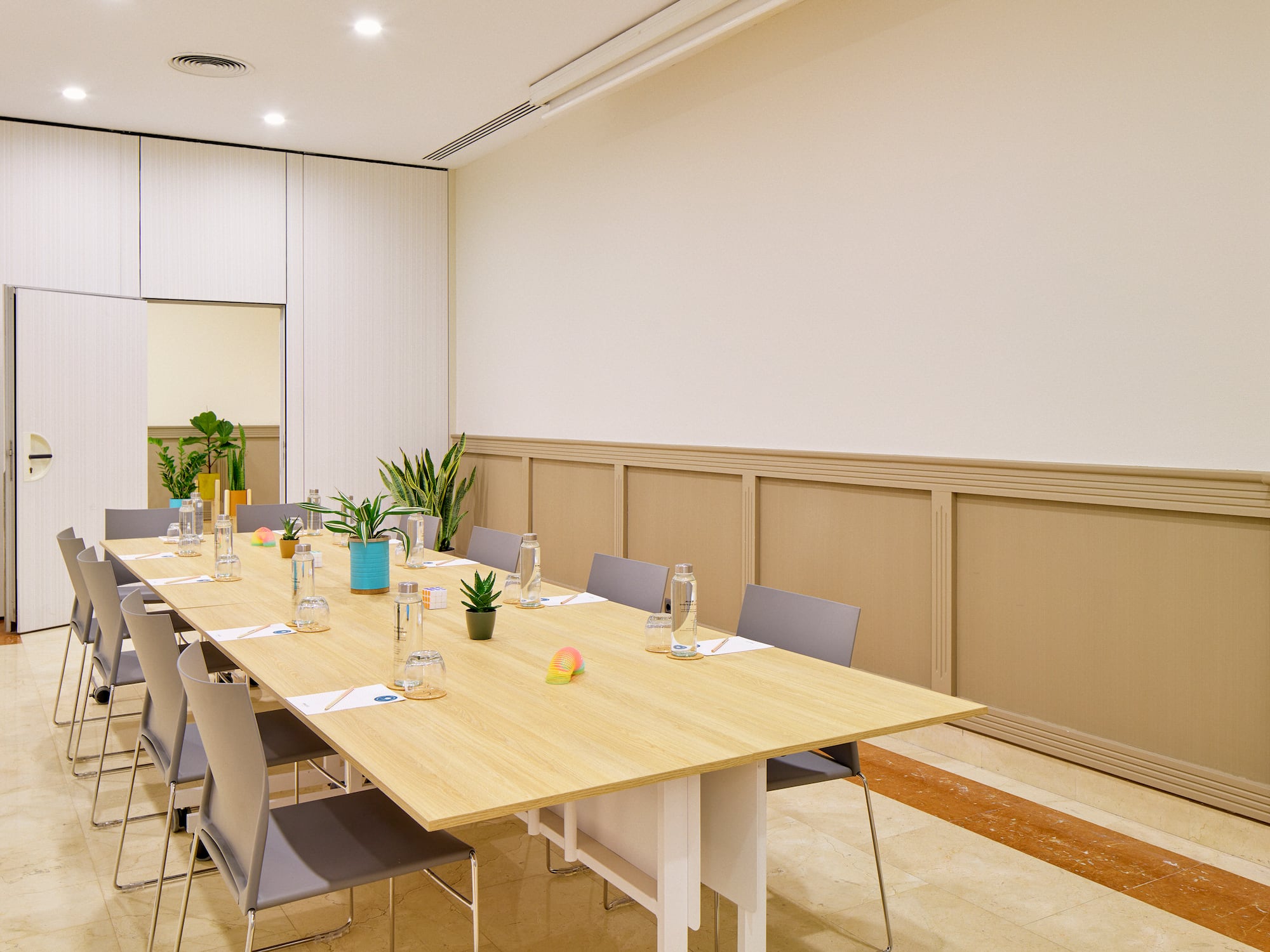 a table with water bottles and plants in a room