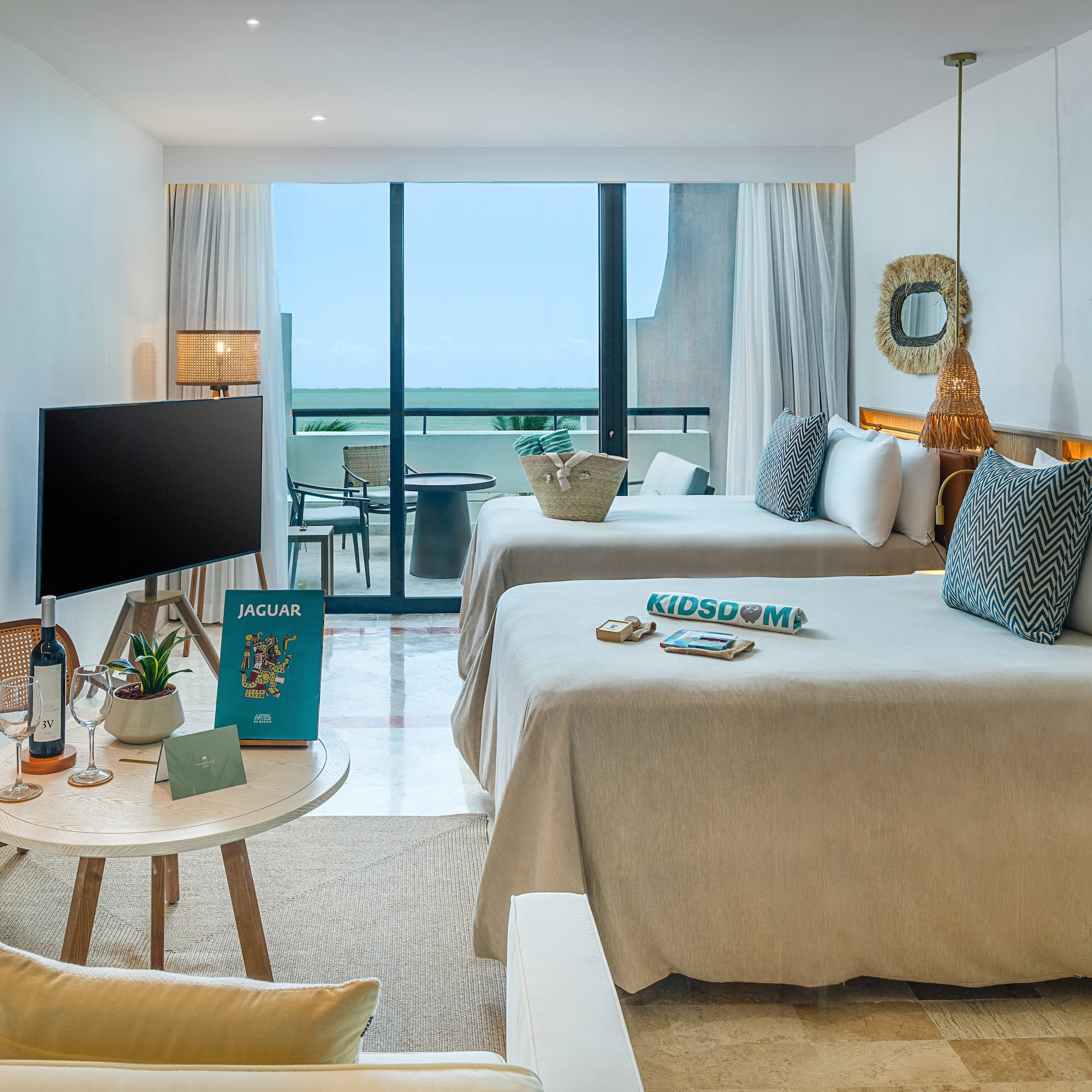 a room with two beds and a television