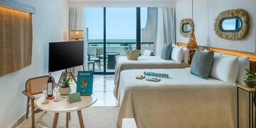 a room with two beds and a television