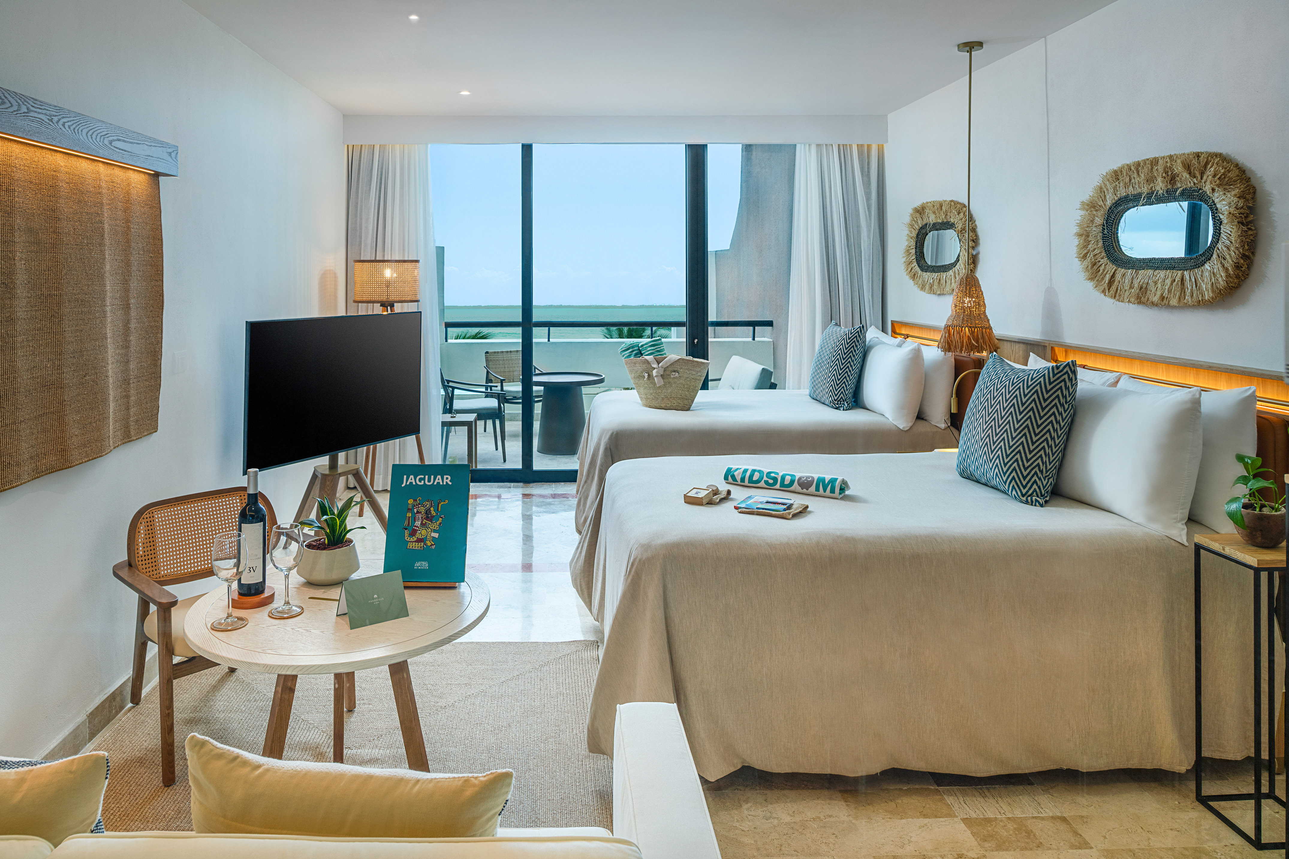 a room with two beds and a television