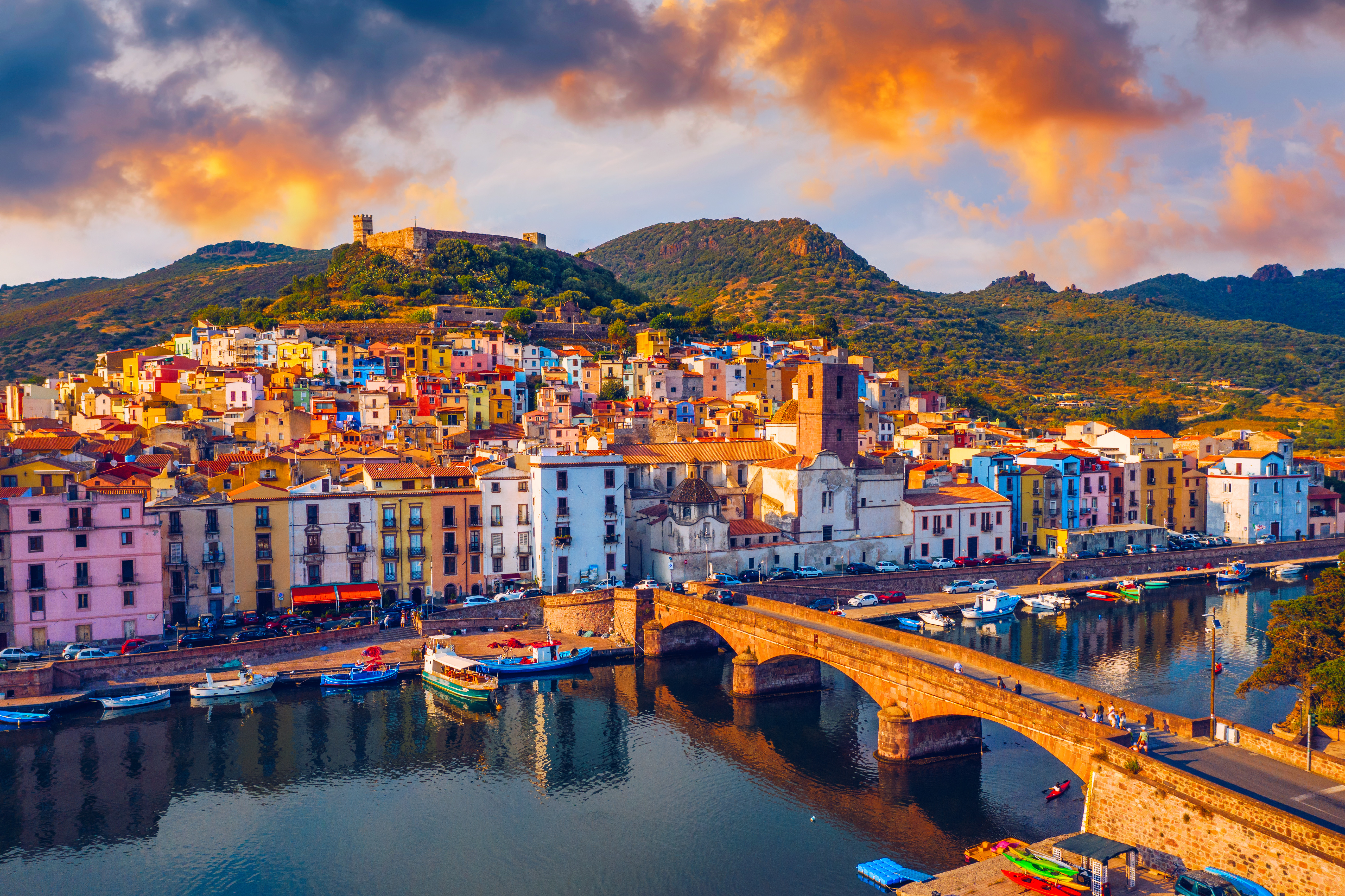 a bridge over water with buildings and boats