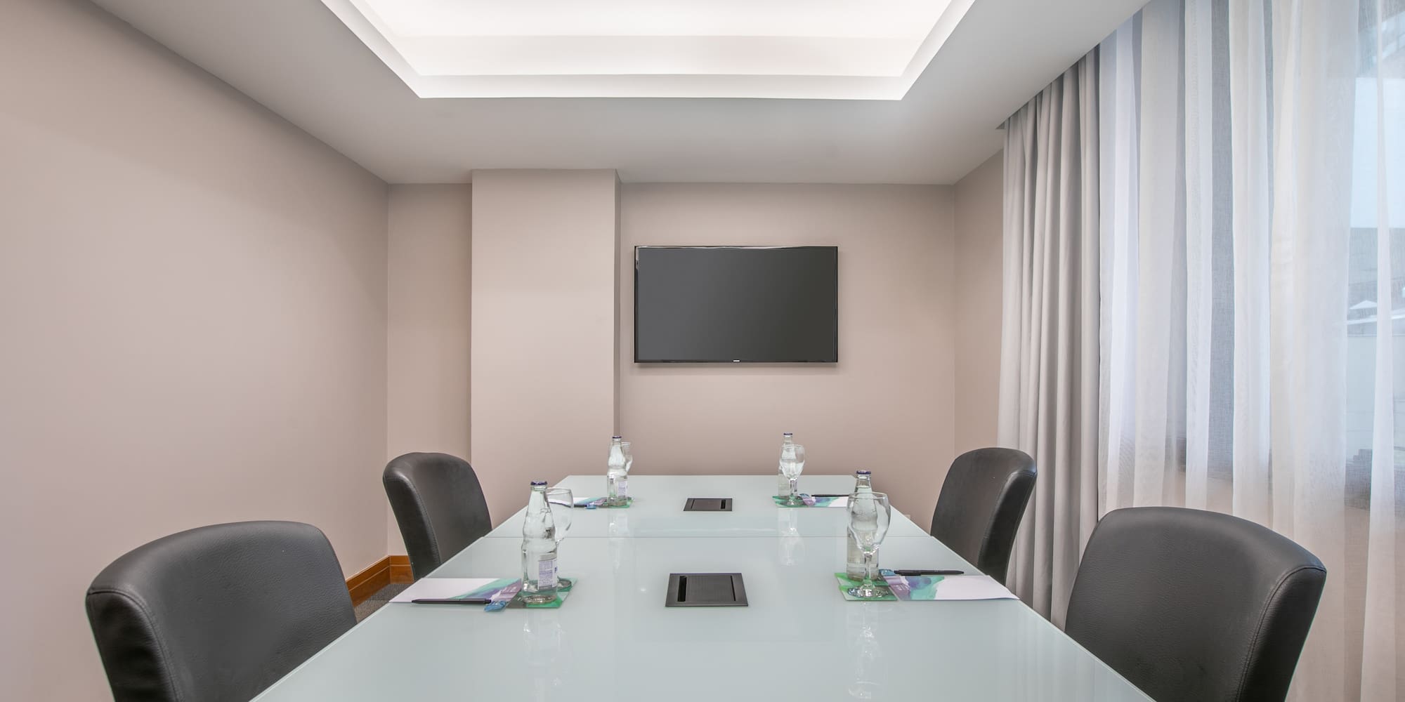 a conference room with a table and chairs