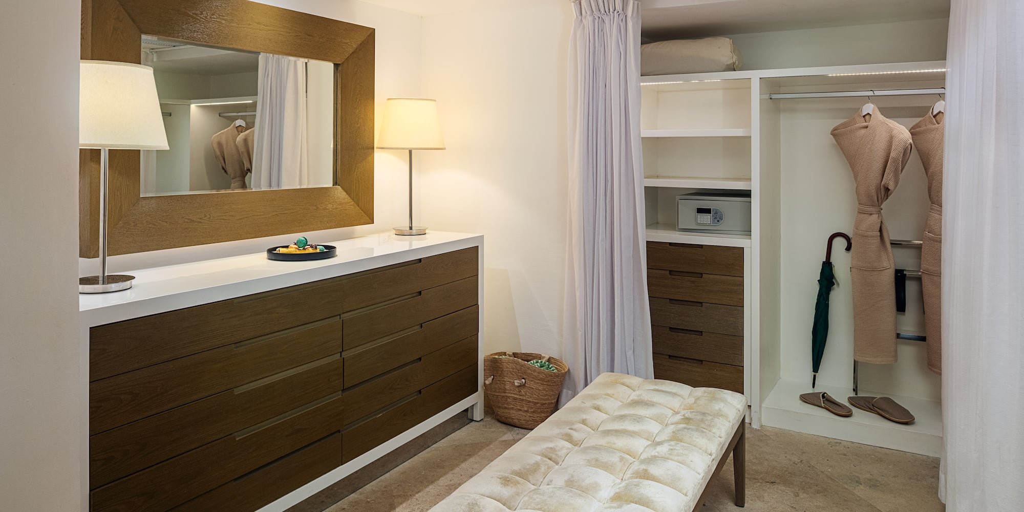 a room with a mirror and dresser