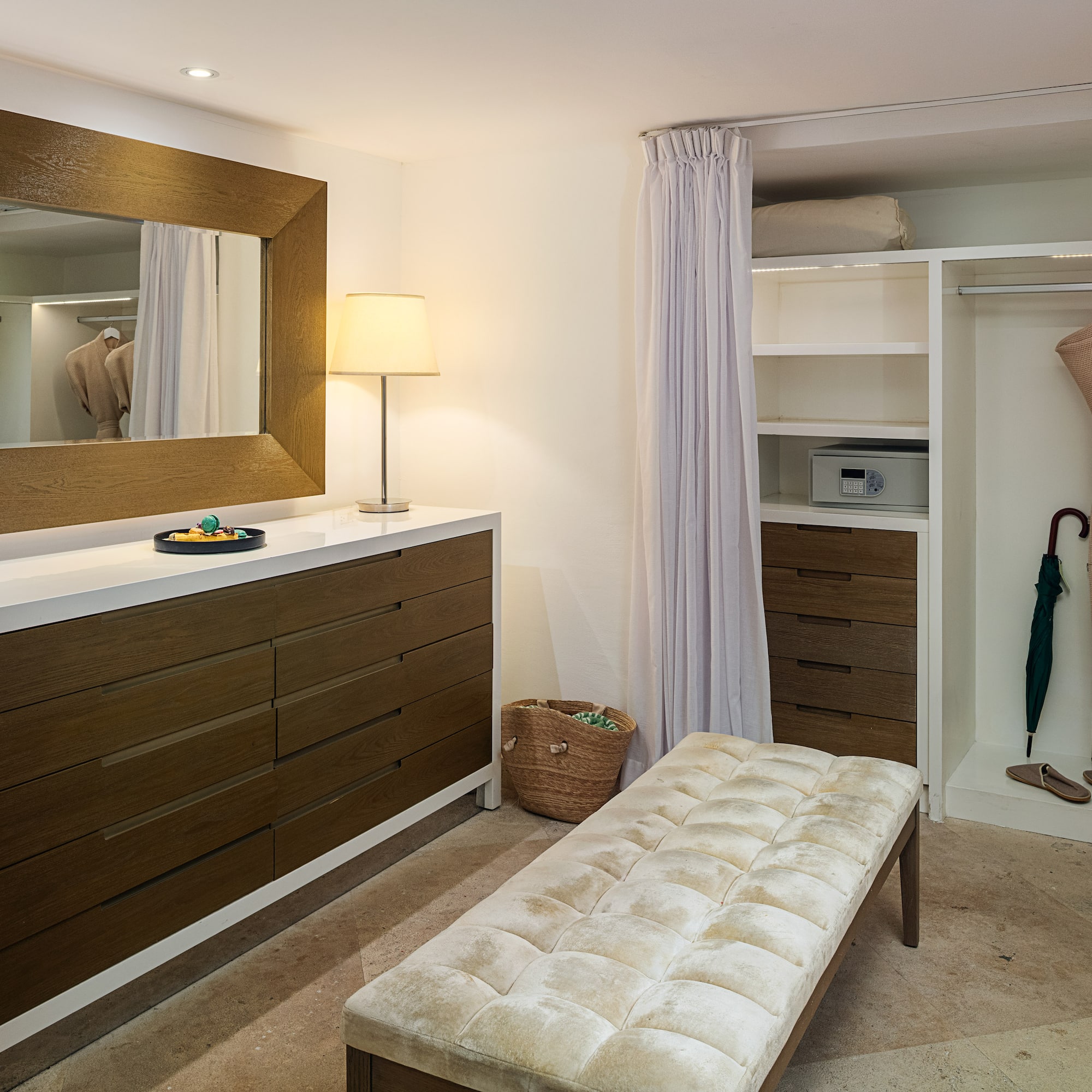 a room with a mirror and dresser