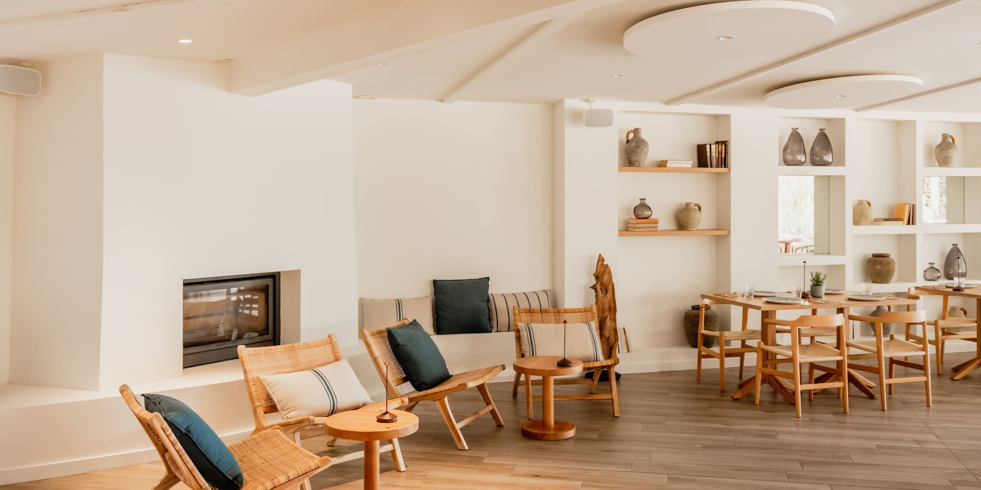 a room with a fireplace and chairs