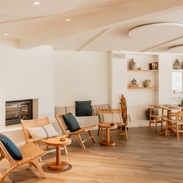 a room with a fireplace and chairs