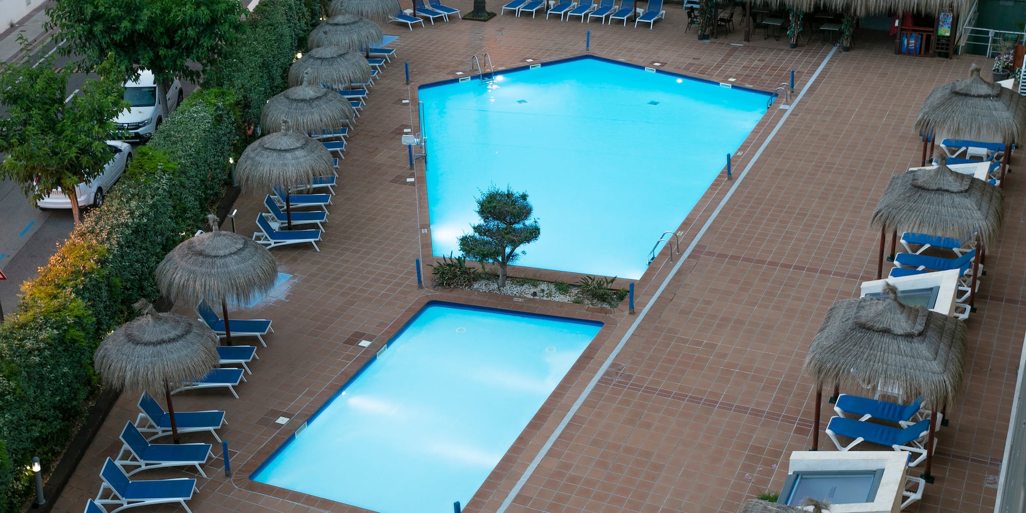 a pool with umbrellas and chairs