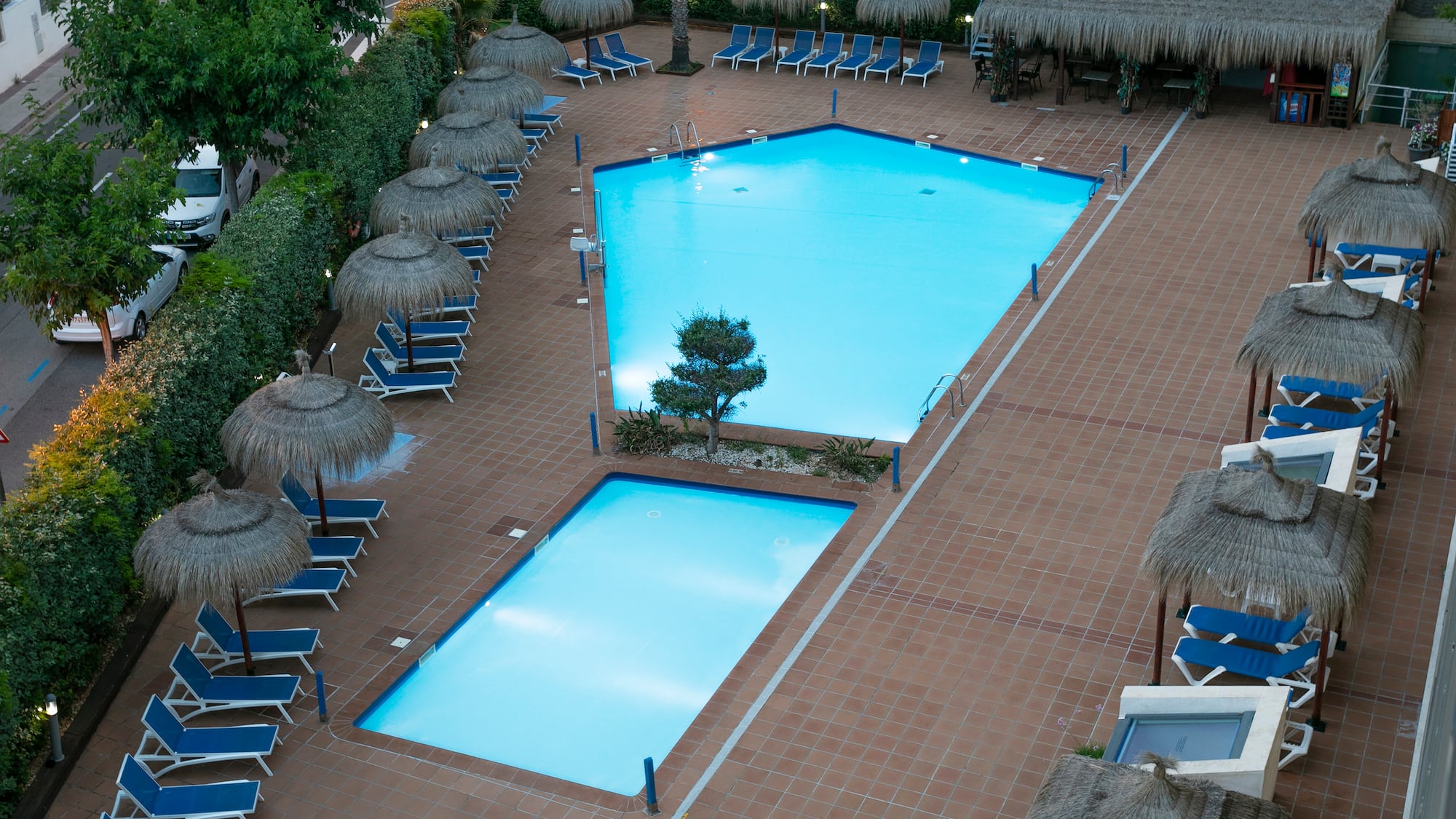 a pool with umbrellas and chairs