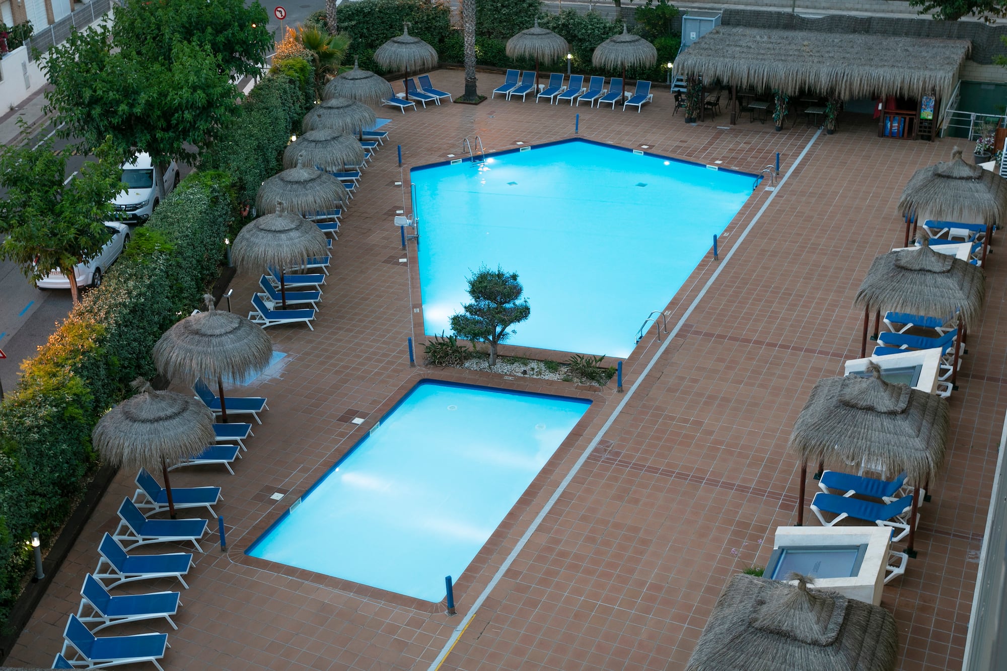 a pool with umbrellas and chairs