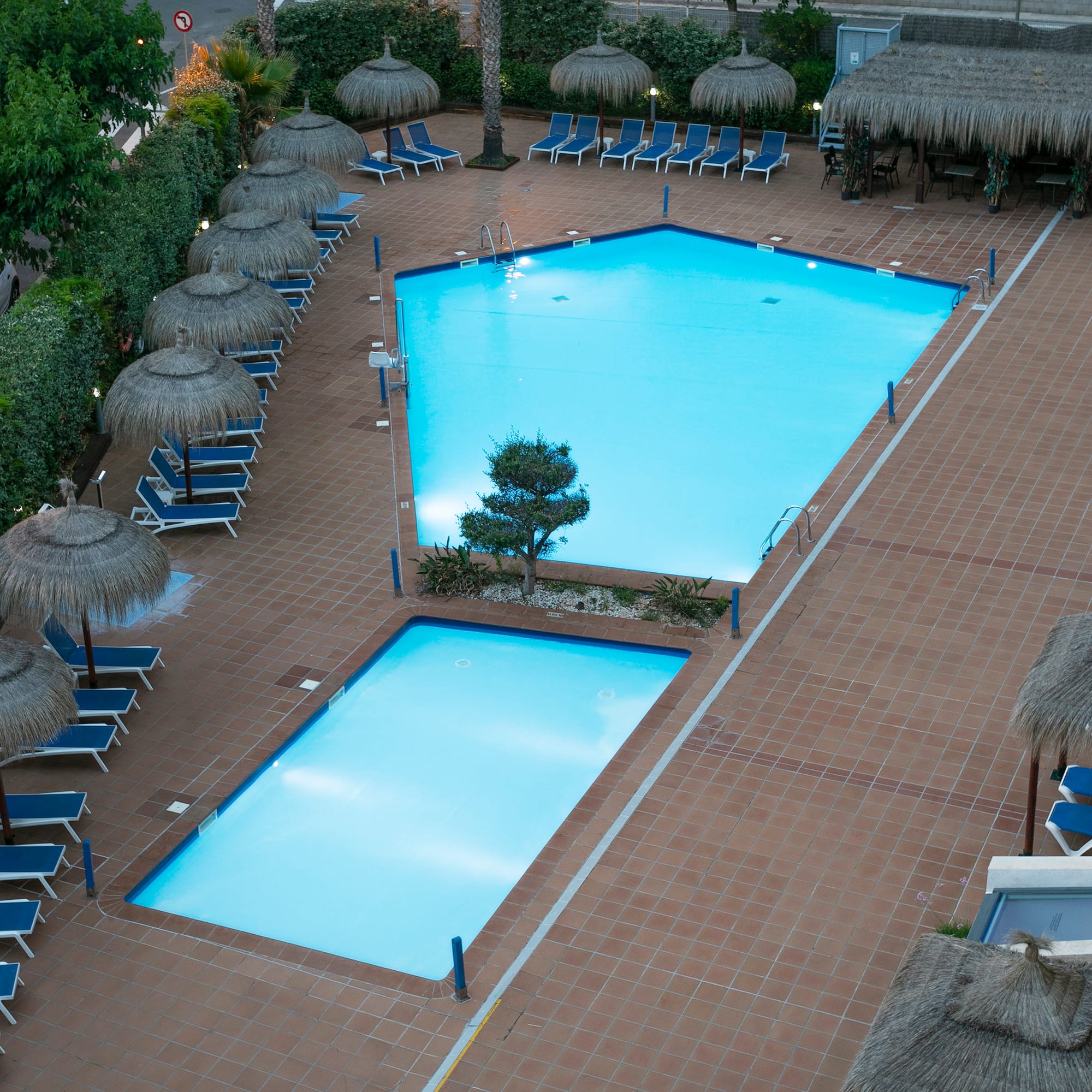 a pool with umbrellas and chairs
