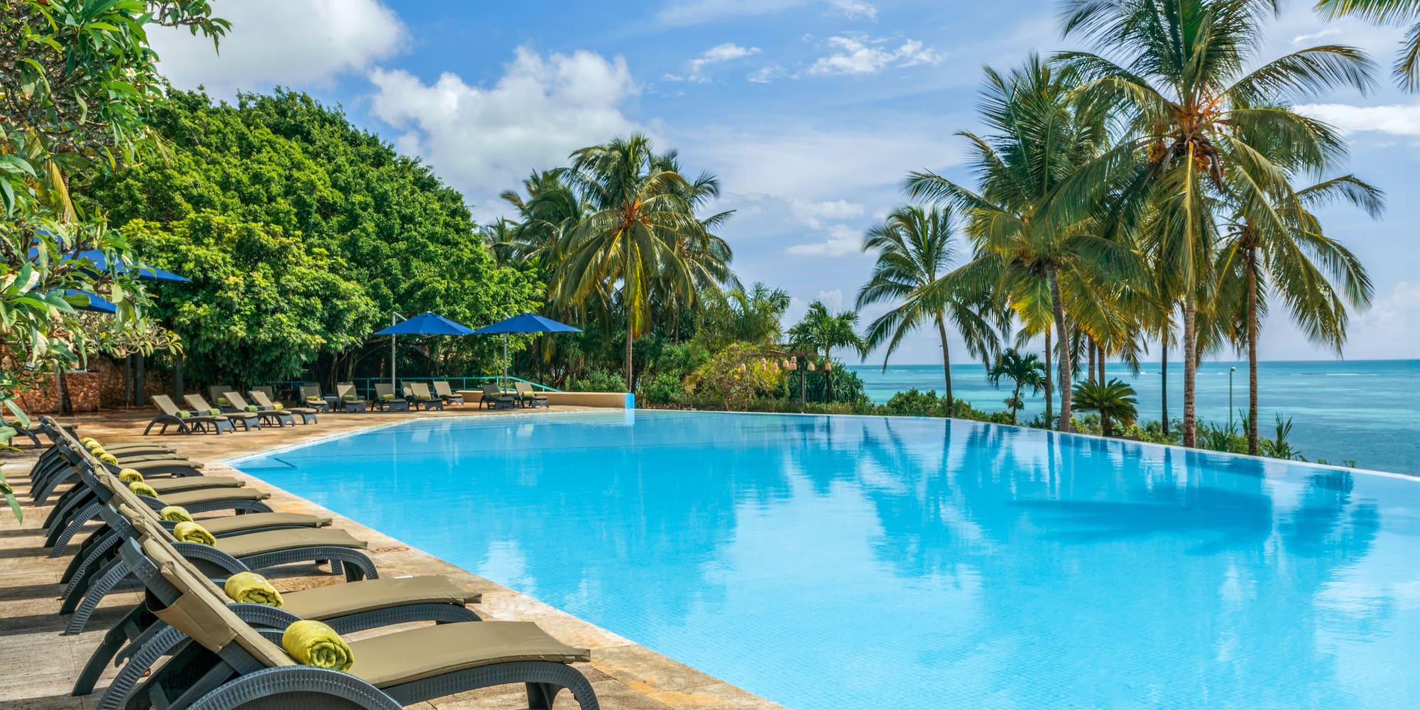 a pool with lounge chairs and umbrellas