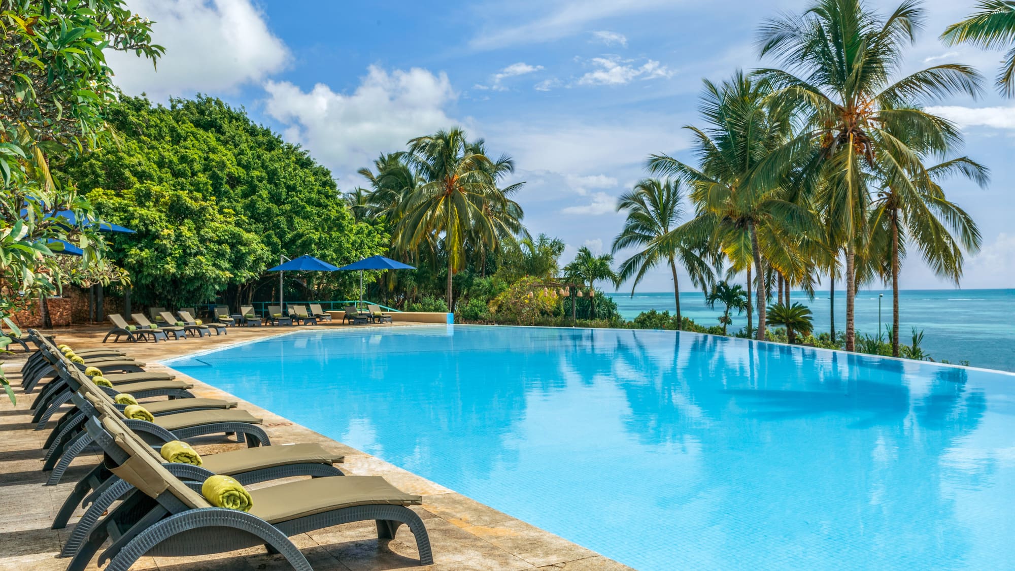 a pool with lounge chairs and umbrellas