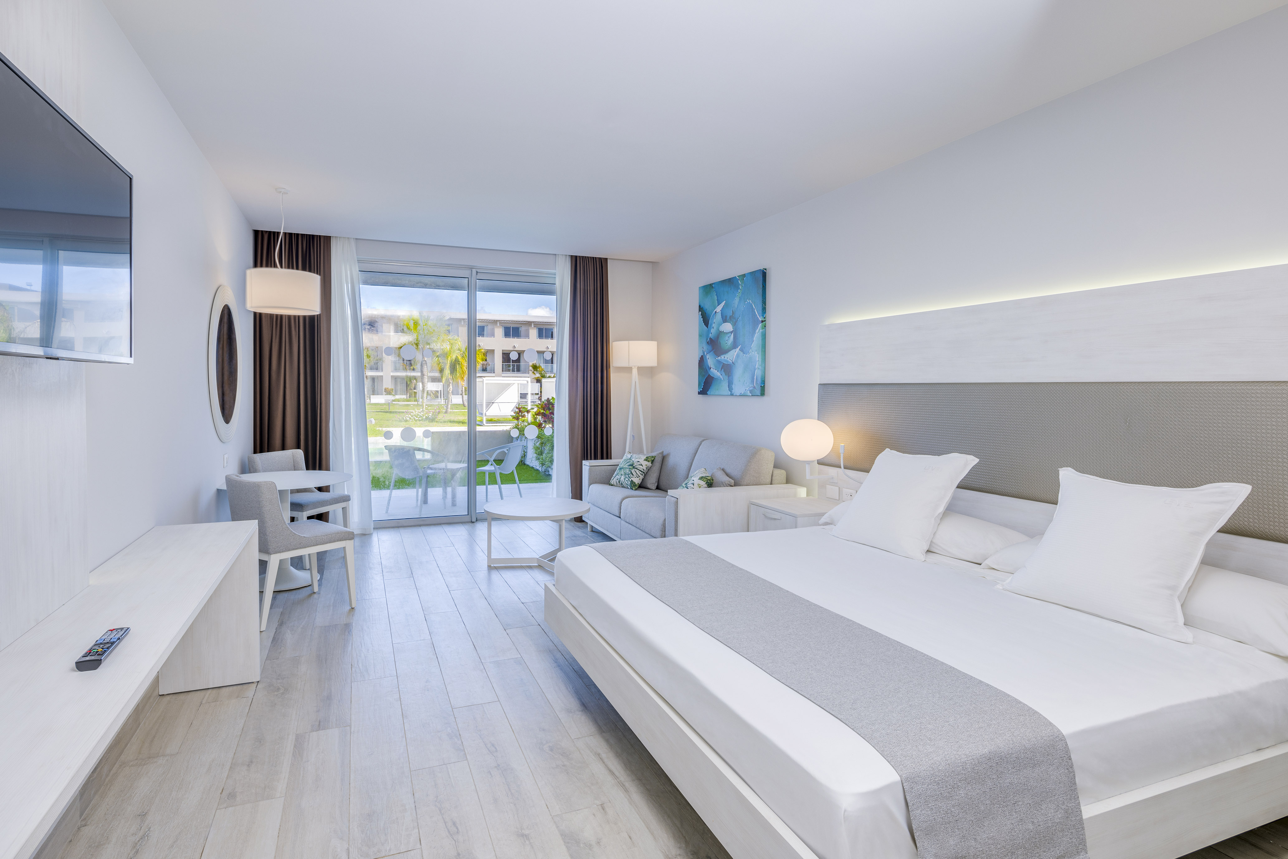 a room with a bed and a table and chairs