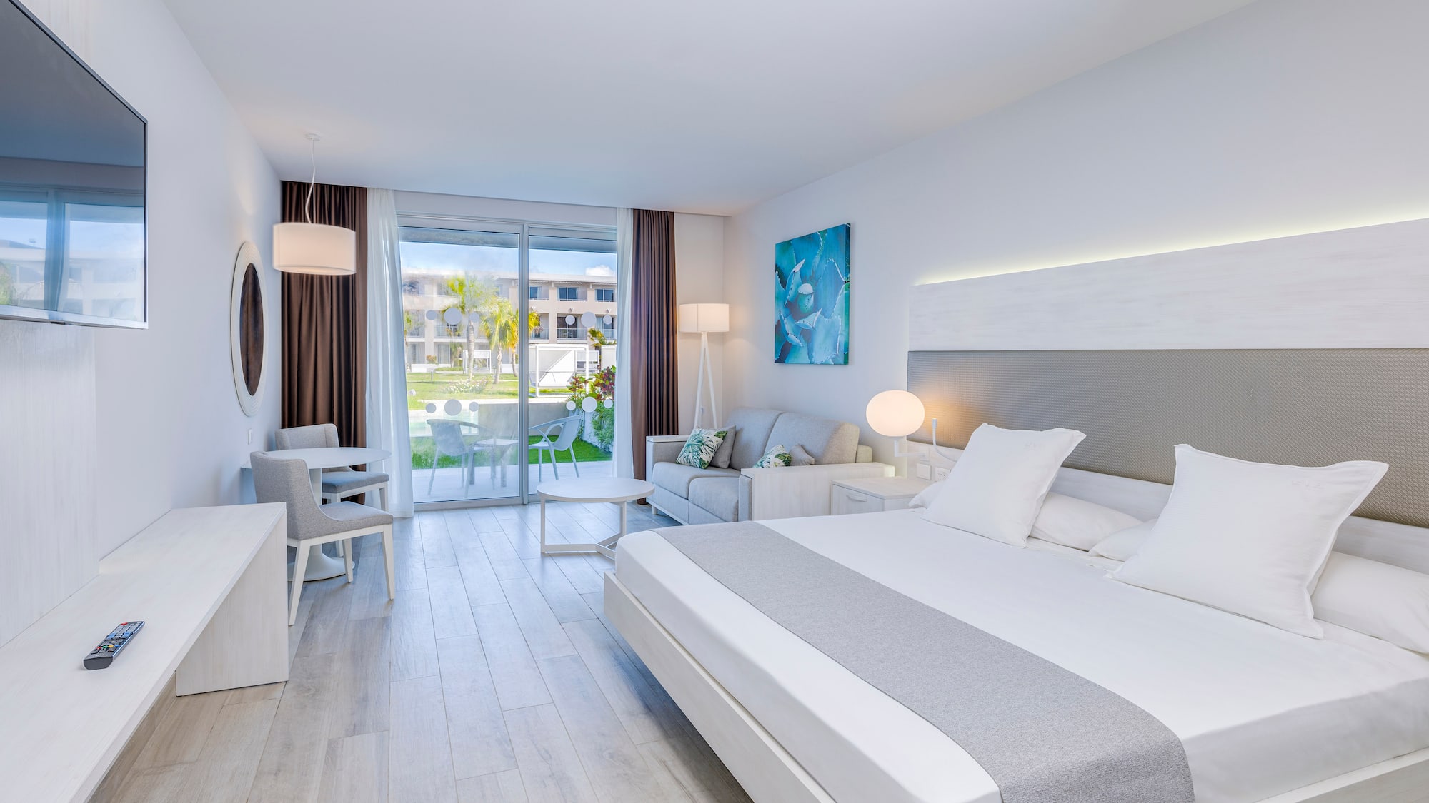 a room with a bed and a table and chairs