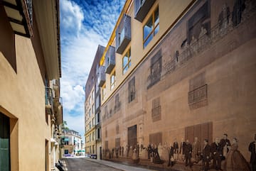 a street with a mural on the side of a building