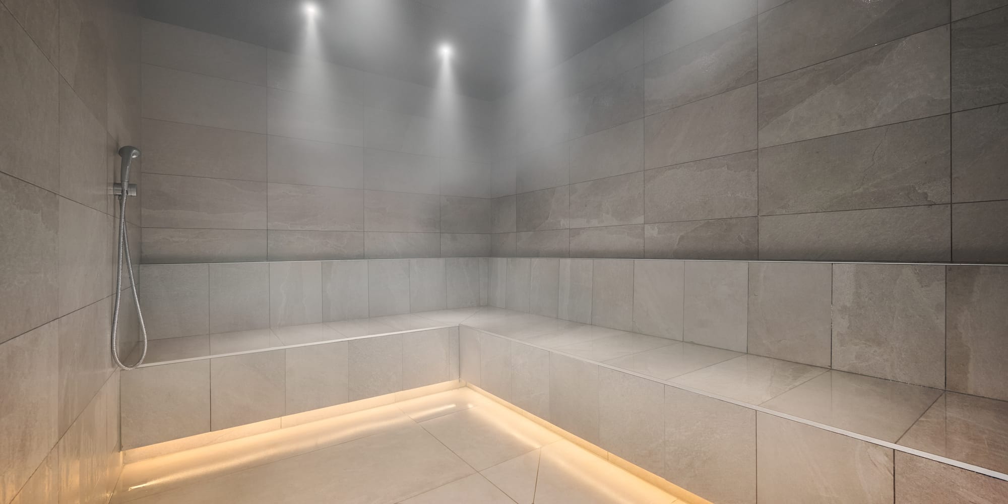 a room with a stone wall and a tile floor