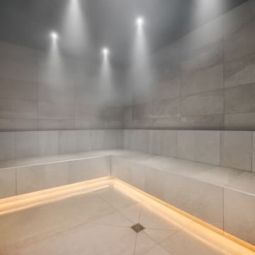 a room with a stone wall and a tile floor