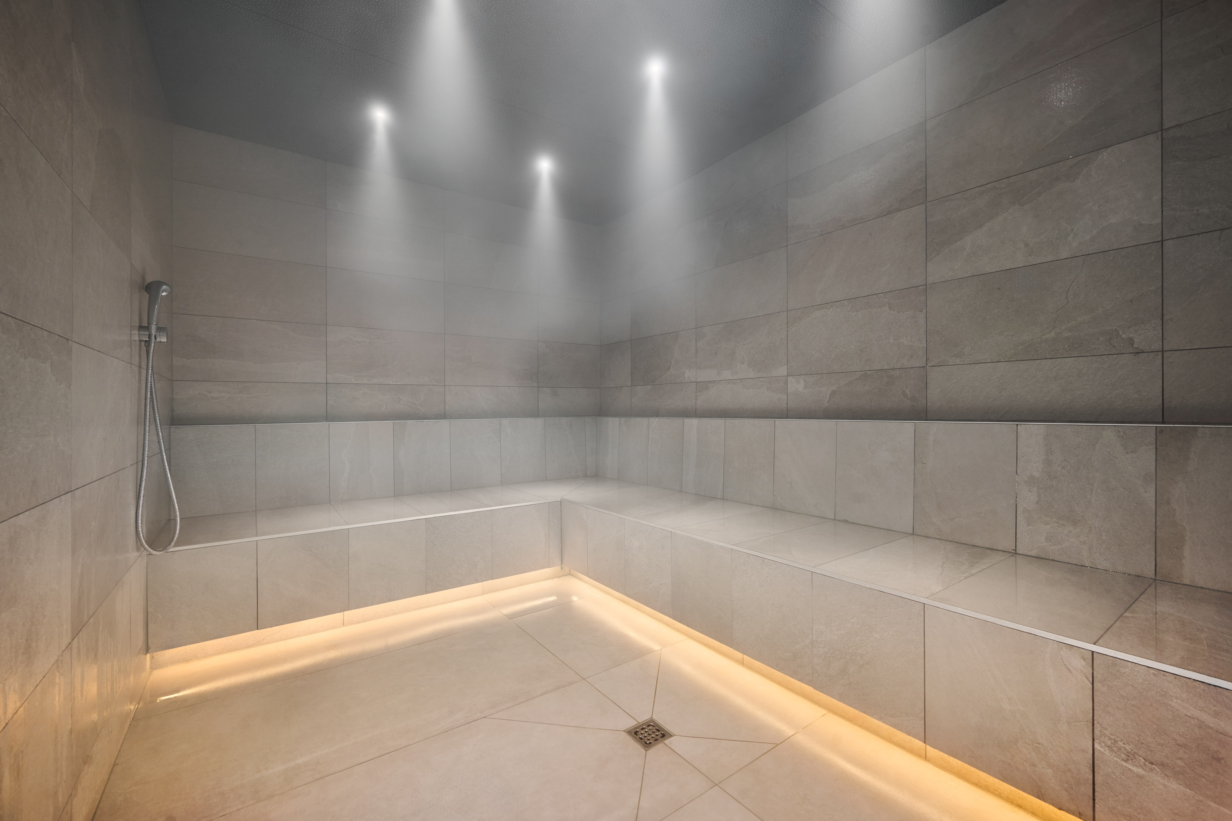 a room with a stone wall and a tile floor