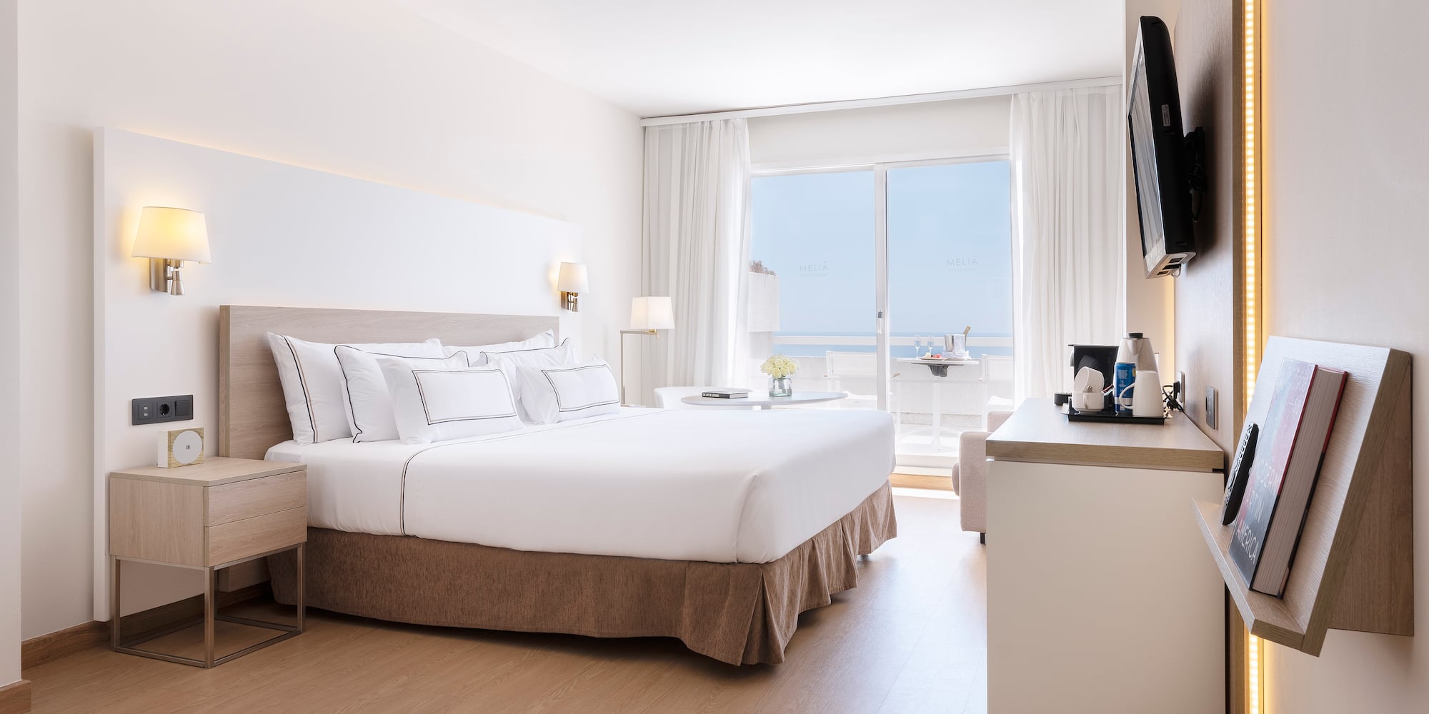 a bedroom with a large bed and a television