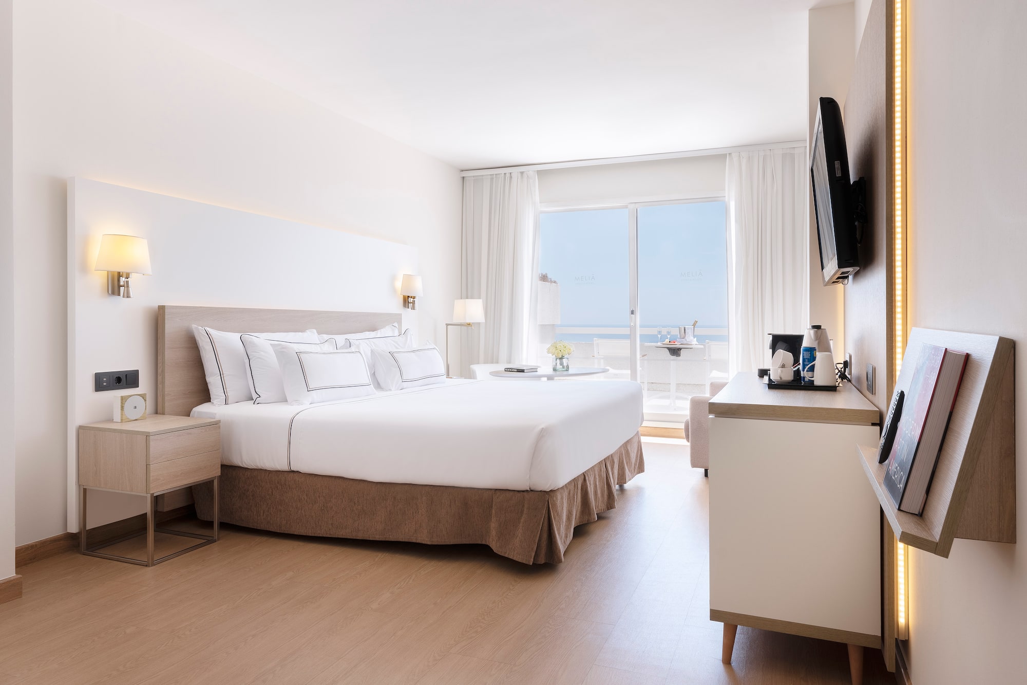 a bedroom with a large bed and a television