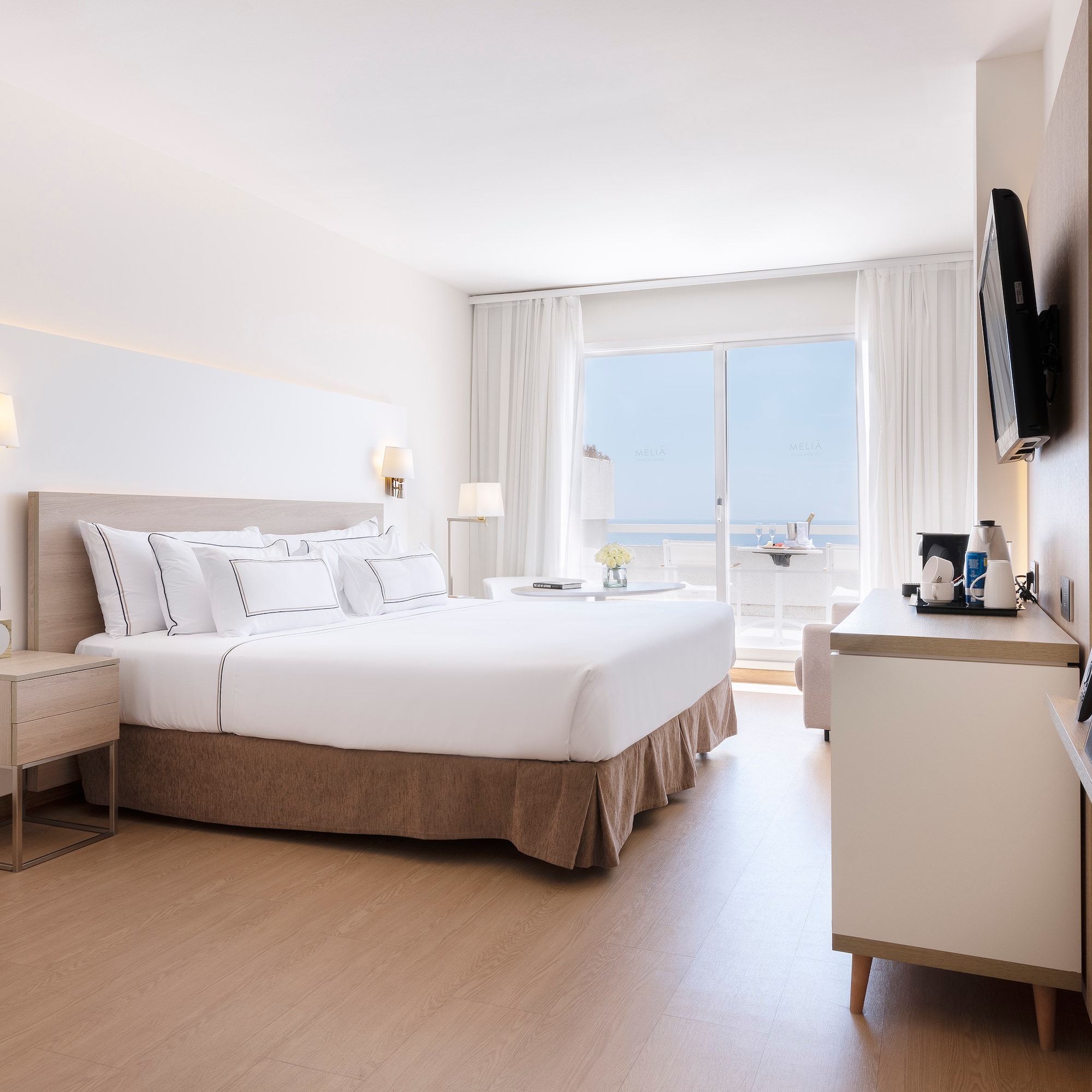 a bedroom with a large bed and a television