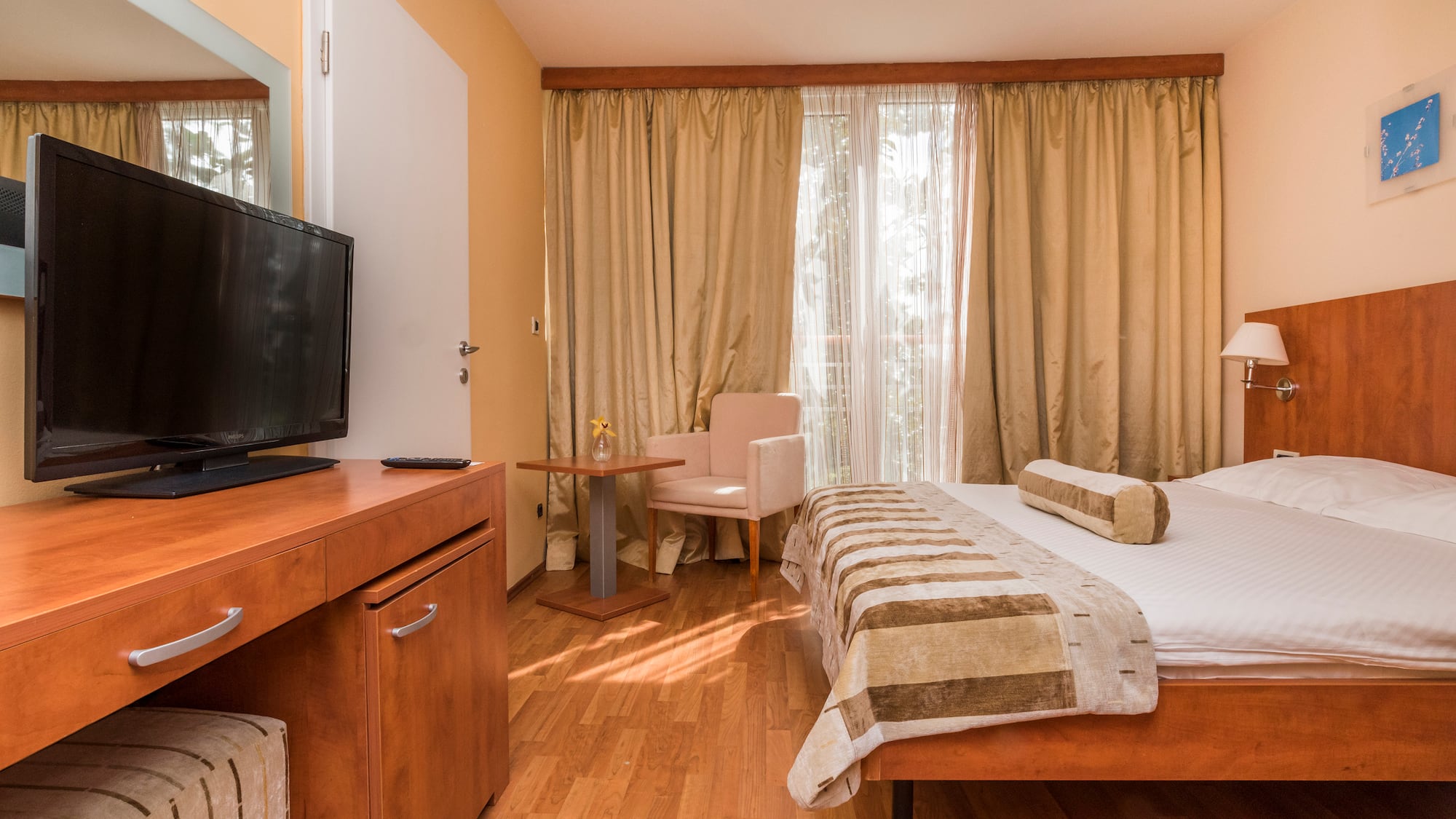 a room with a bed and a television