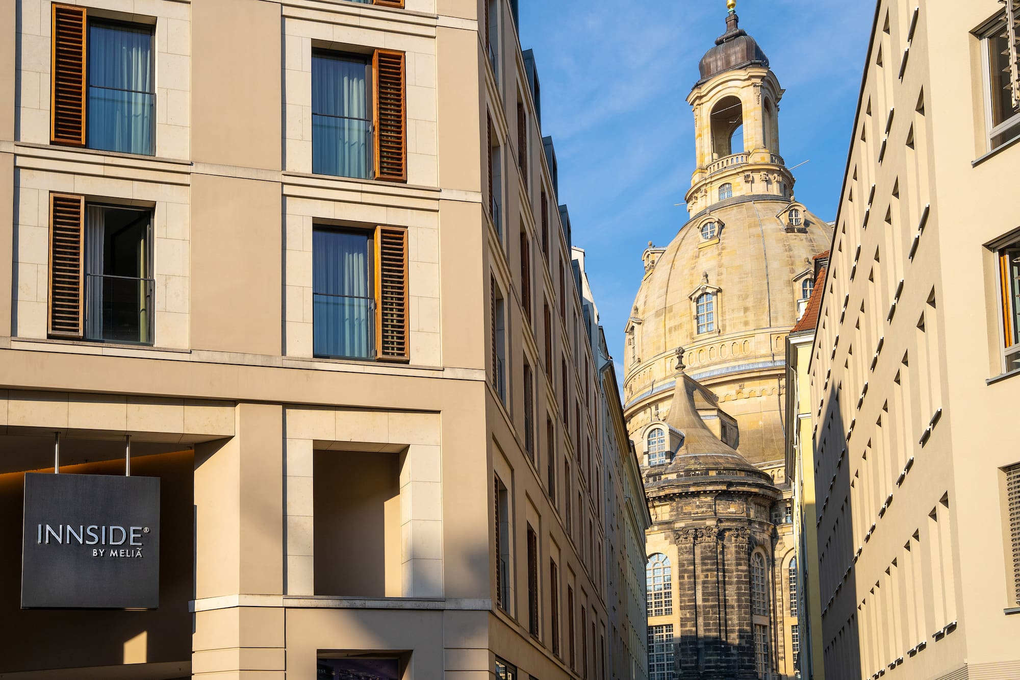 INNSIDE by MELIA hotel building with Frauenkirche dome in Dresden cityscape.