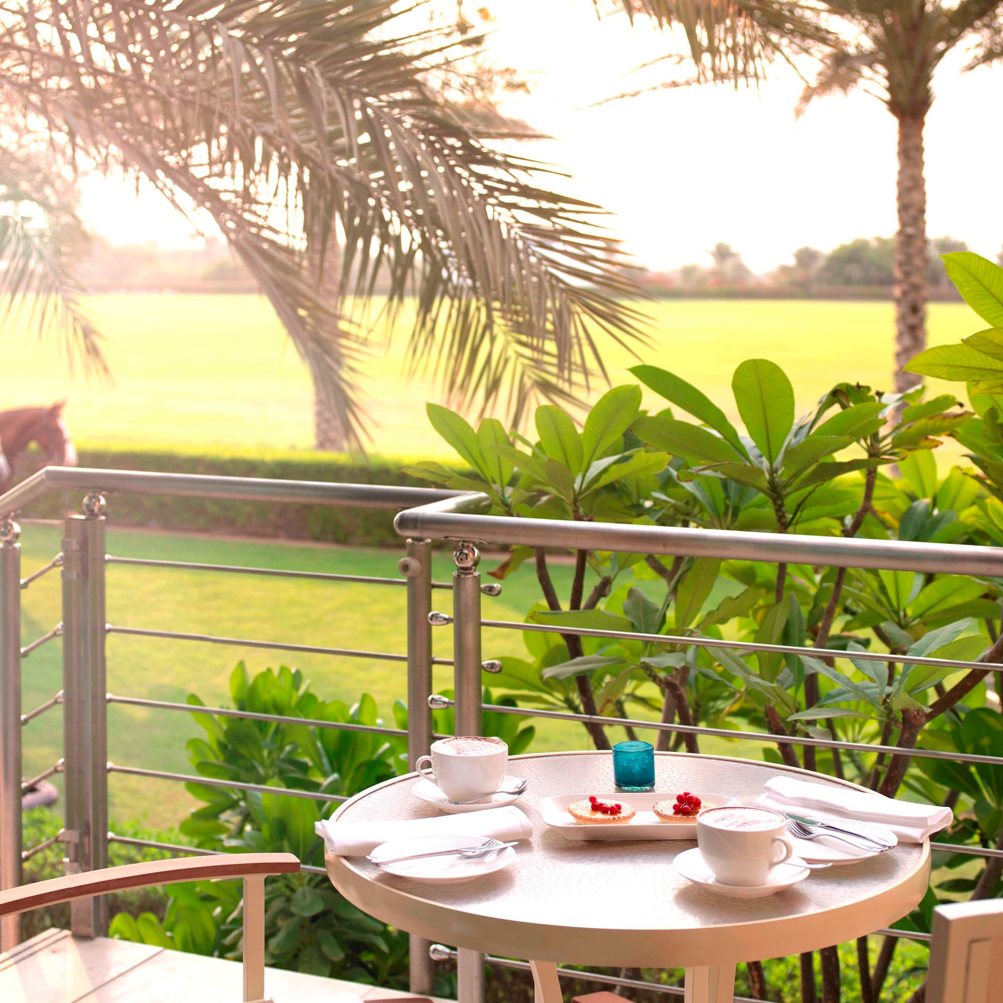 a table with food on it and a table with a horse in the background