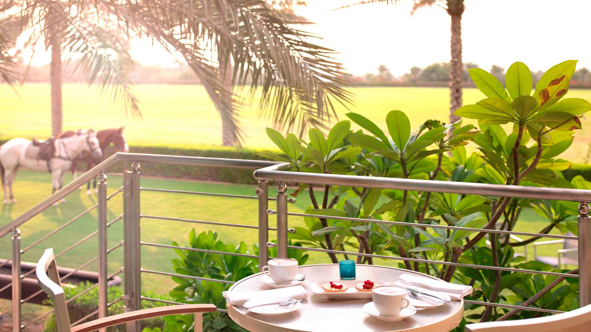 a table with food on it and a table with a horse in the background