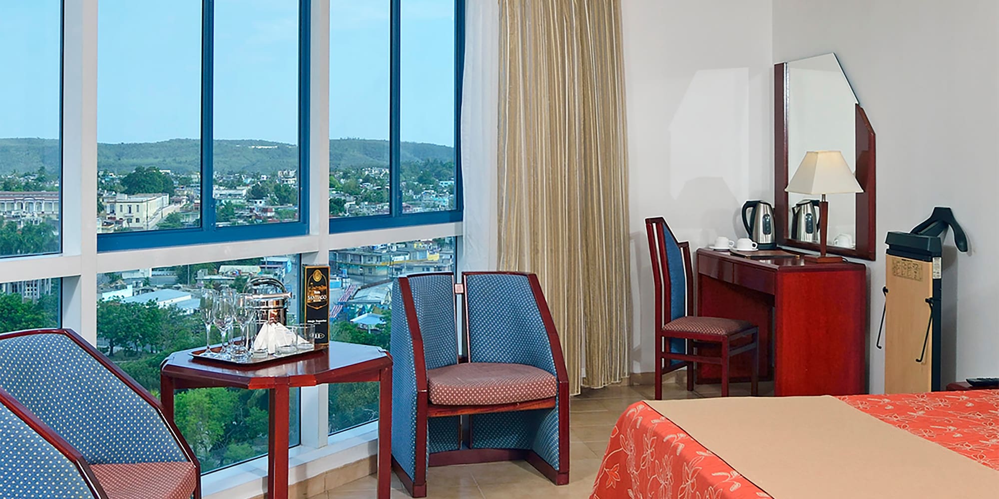 a room with a bed and chairs and a table