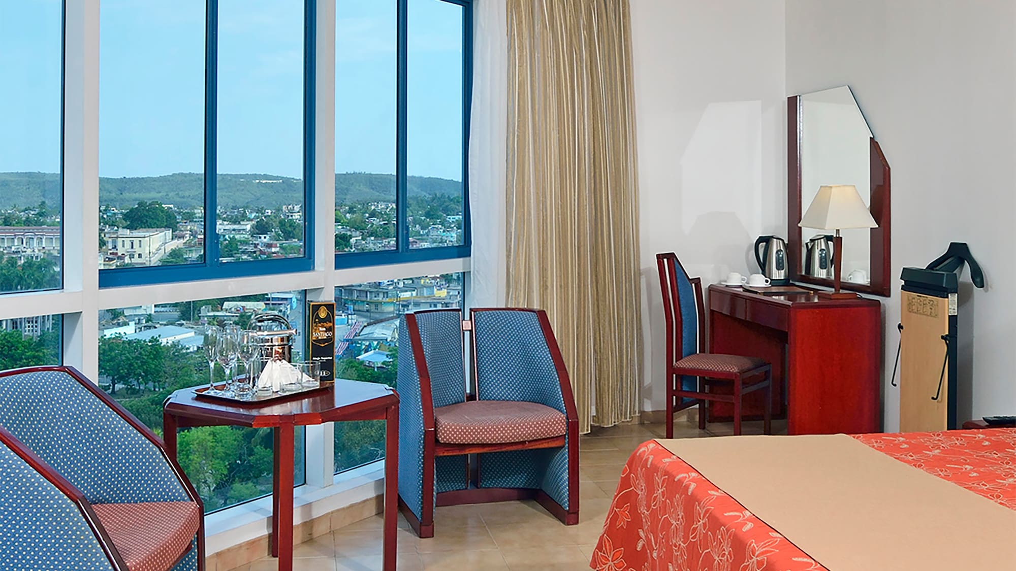 a room with a bed and chairs and a table