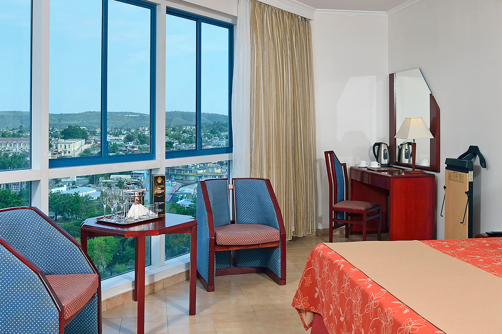 a room with a bed and chairs and a table