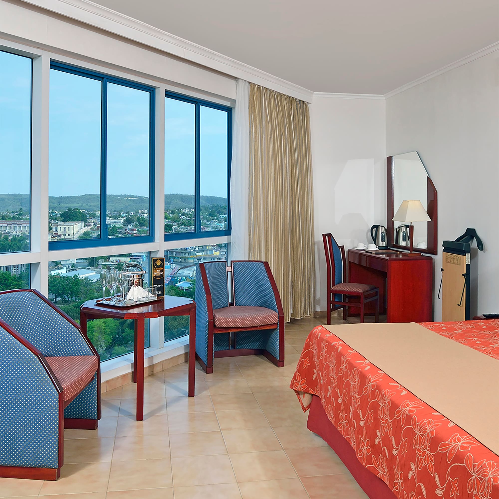 a room with a bed and chairs and a table