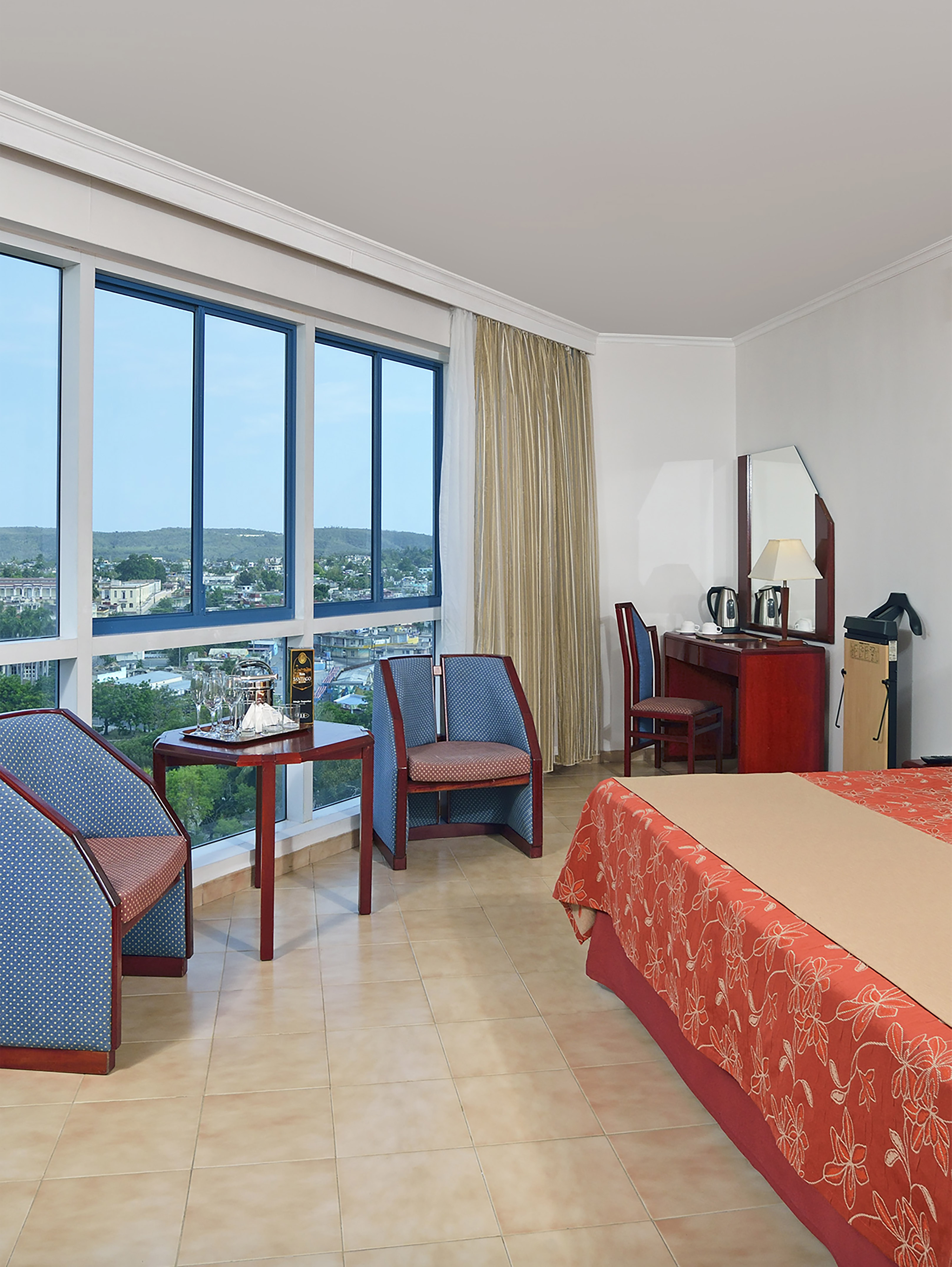 a room with a bed and chairs and a table