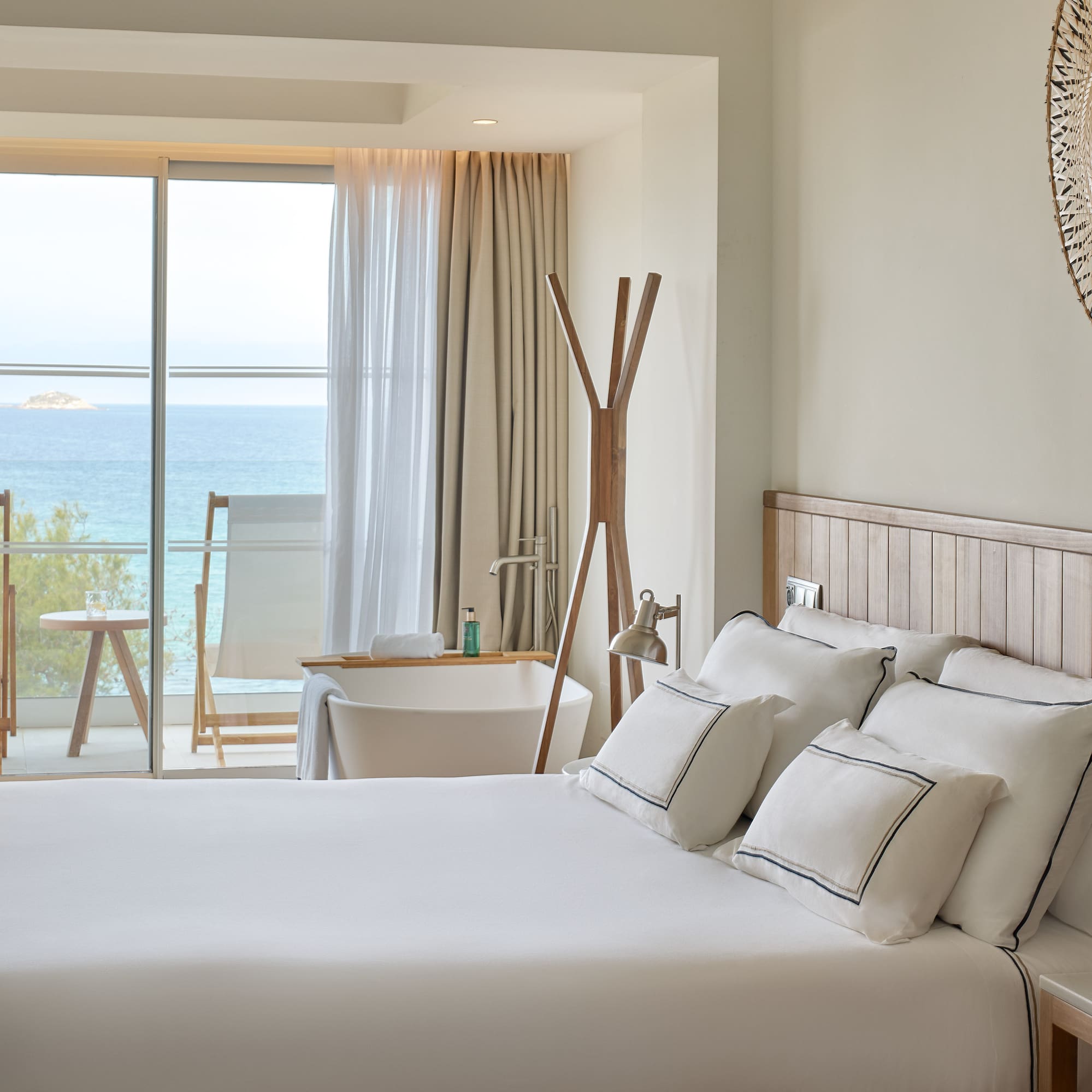 a bedroom with a large window overlooking the ocean