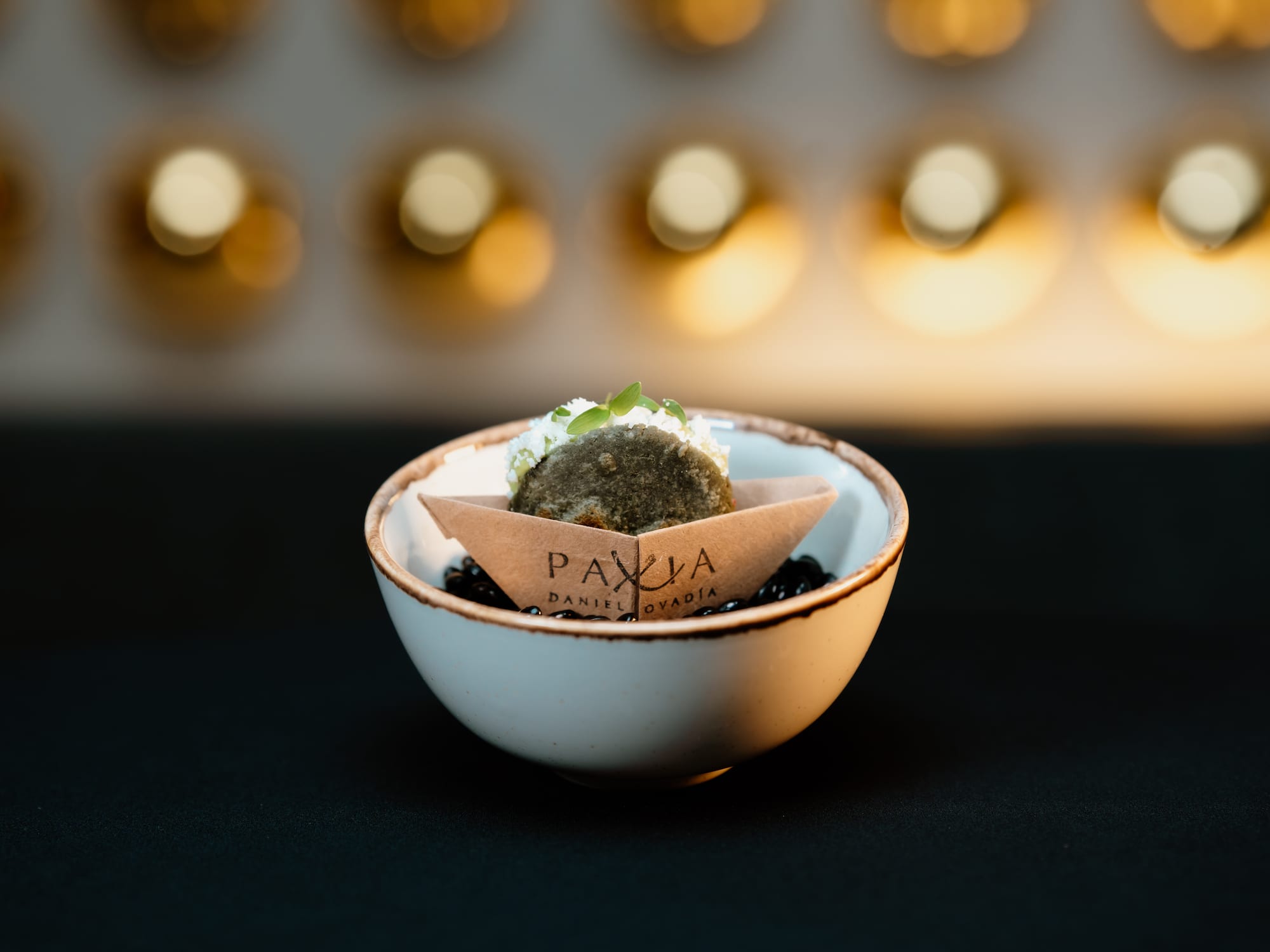 a small white bowl with a cookie in it