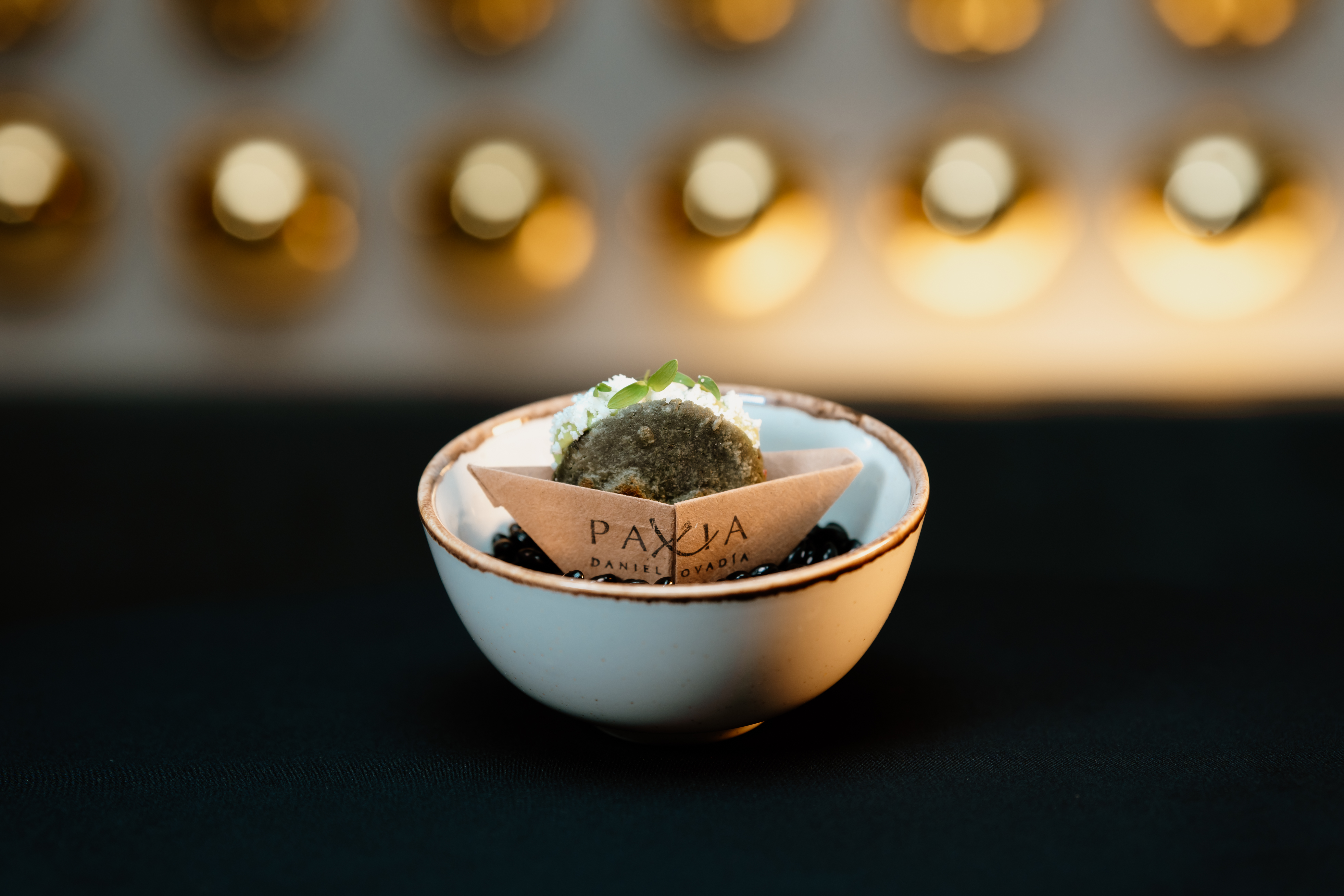 a small white bowl with a cookie in it