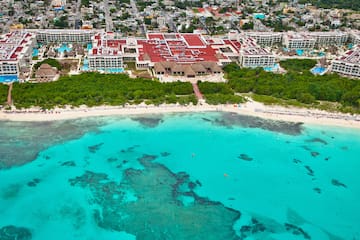 a beach with a building and trees