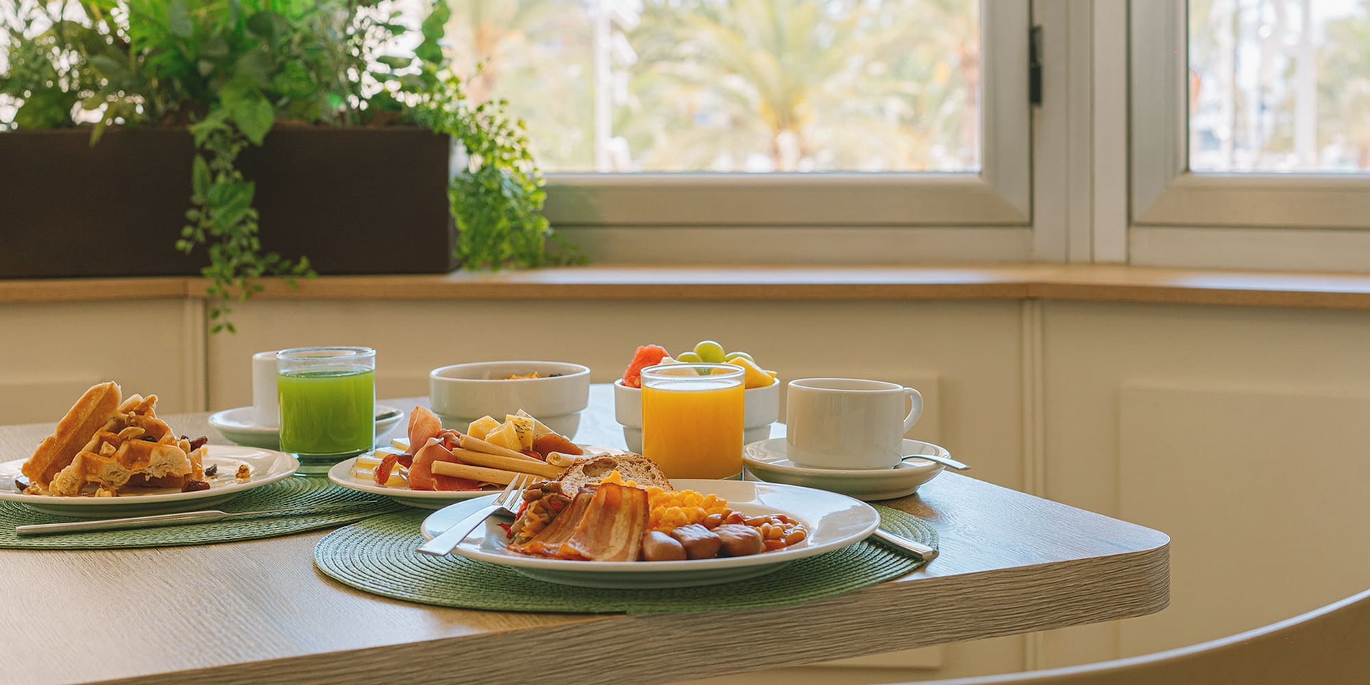 a table with plates of food and drinks