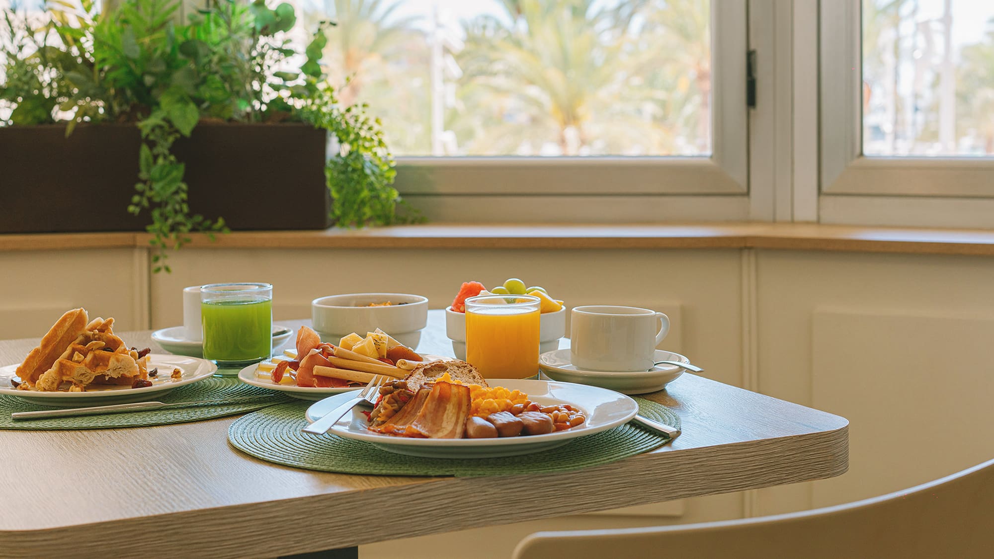 a table with plates of food and drinks