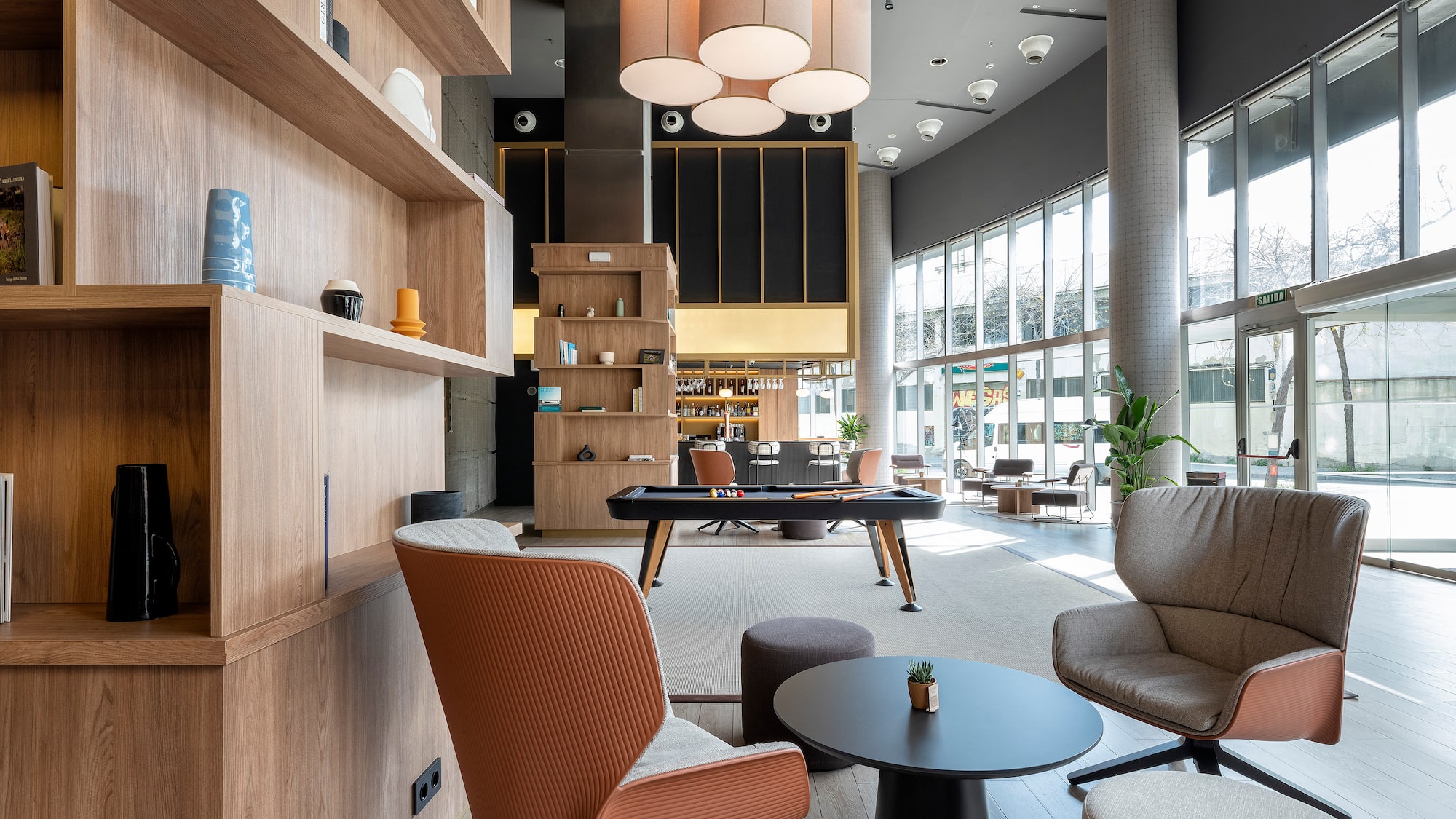 a room with a pool table and chairs