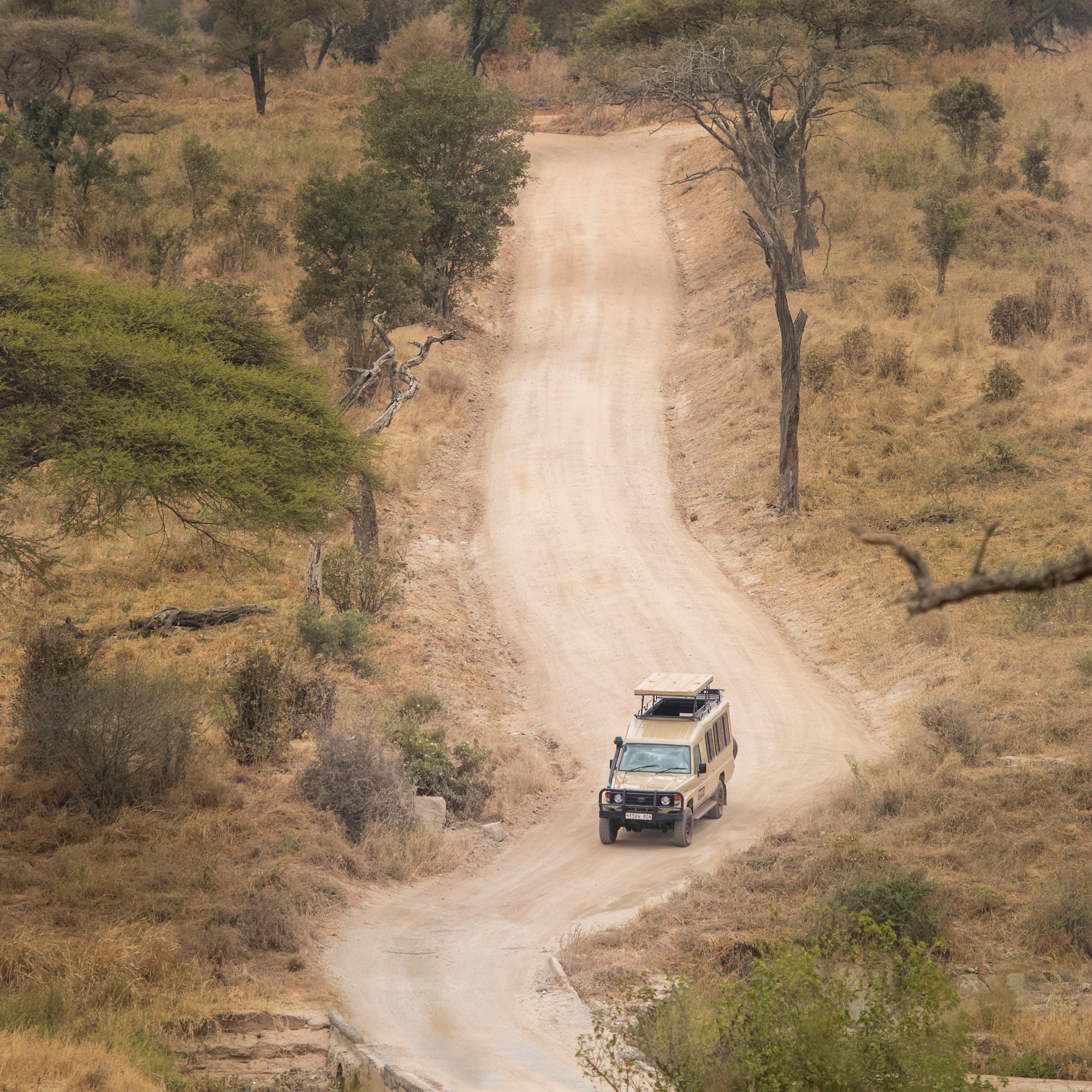 a car driving on a dirt road