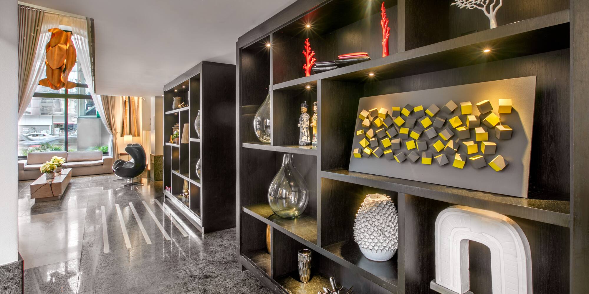 a room with shelves and a large window