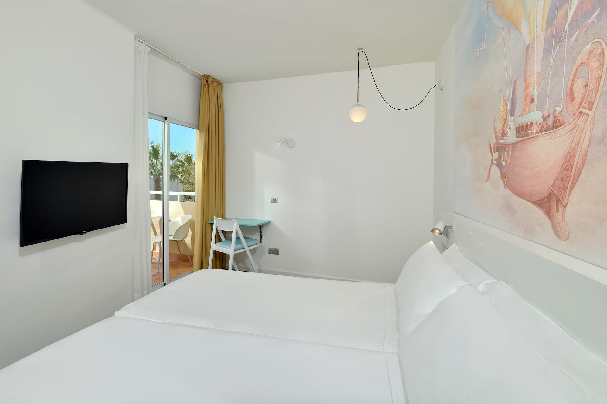 a room with a bed and a television