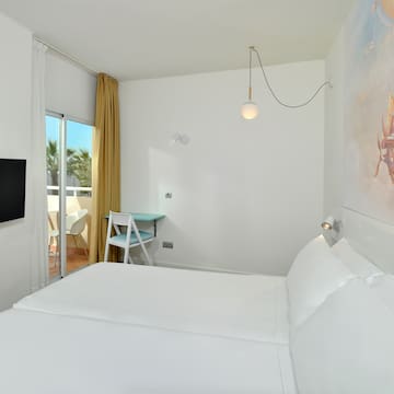 a room with a bed and a television