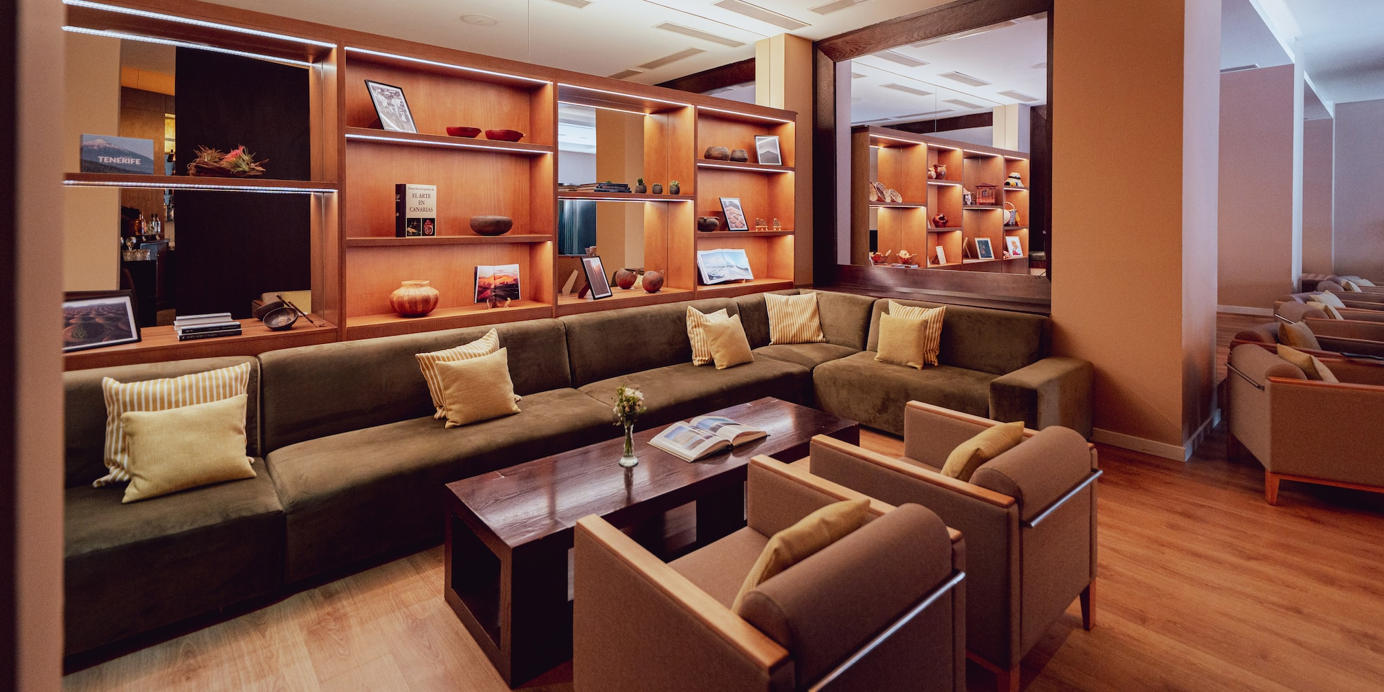 a room with a couch and chairs